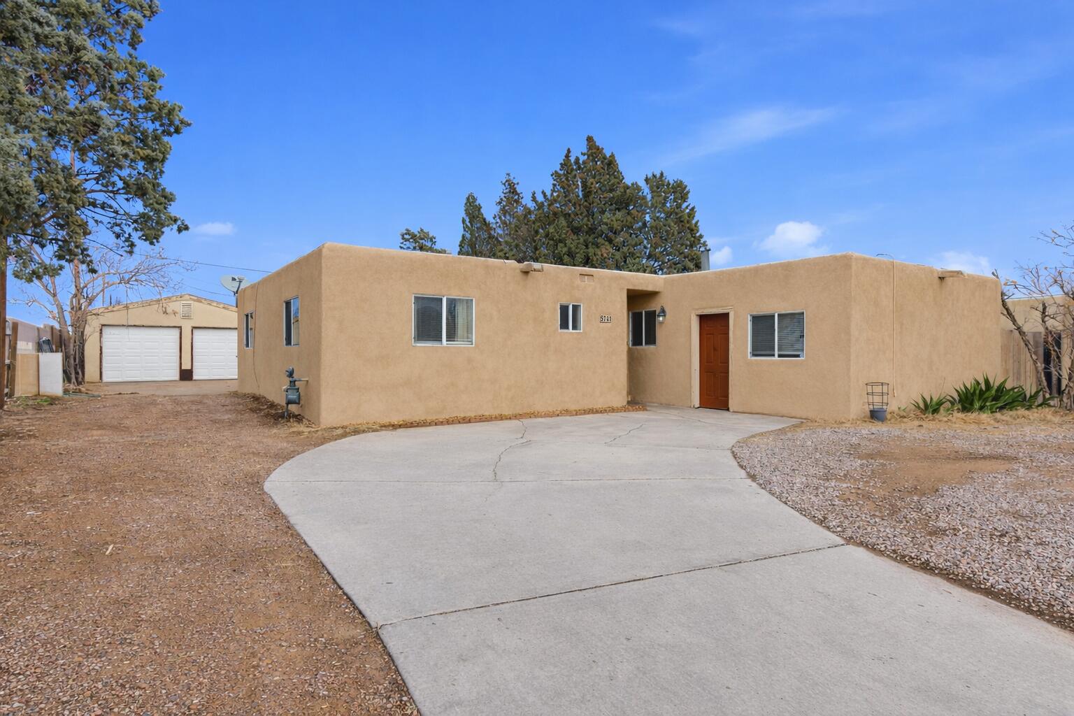 Move-in ready single-story Pueblo-style home full of potential! Situated on a huge lot with possible backyard access, plus an oversized detached two-car garage--perfect for a workshop, studio, or band practice without disturbing the home. Features 3 bedrooms in the main house and a converted garage studio suite with separate access and water closet, ideal for a 4th bedroom, office, or hobby room. TPO roof only 3 years old, refrigerated air and furnace installed in 2020, and brand-new stucco in 2026. Expanded living room from an enclosed patio offers generous space, anchored by a stunning wood-burning fireplace. Separate dining area beside a charming kitchen with stainless steel appliances. Ceiling fans throughout. Prime location near shopping, dining, and easy freeway access.