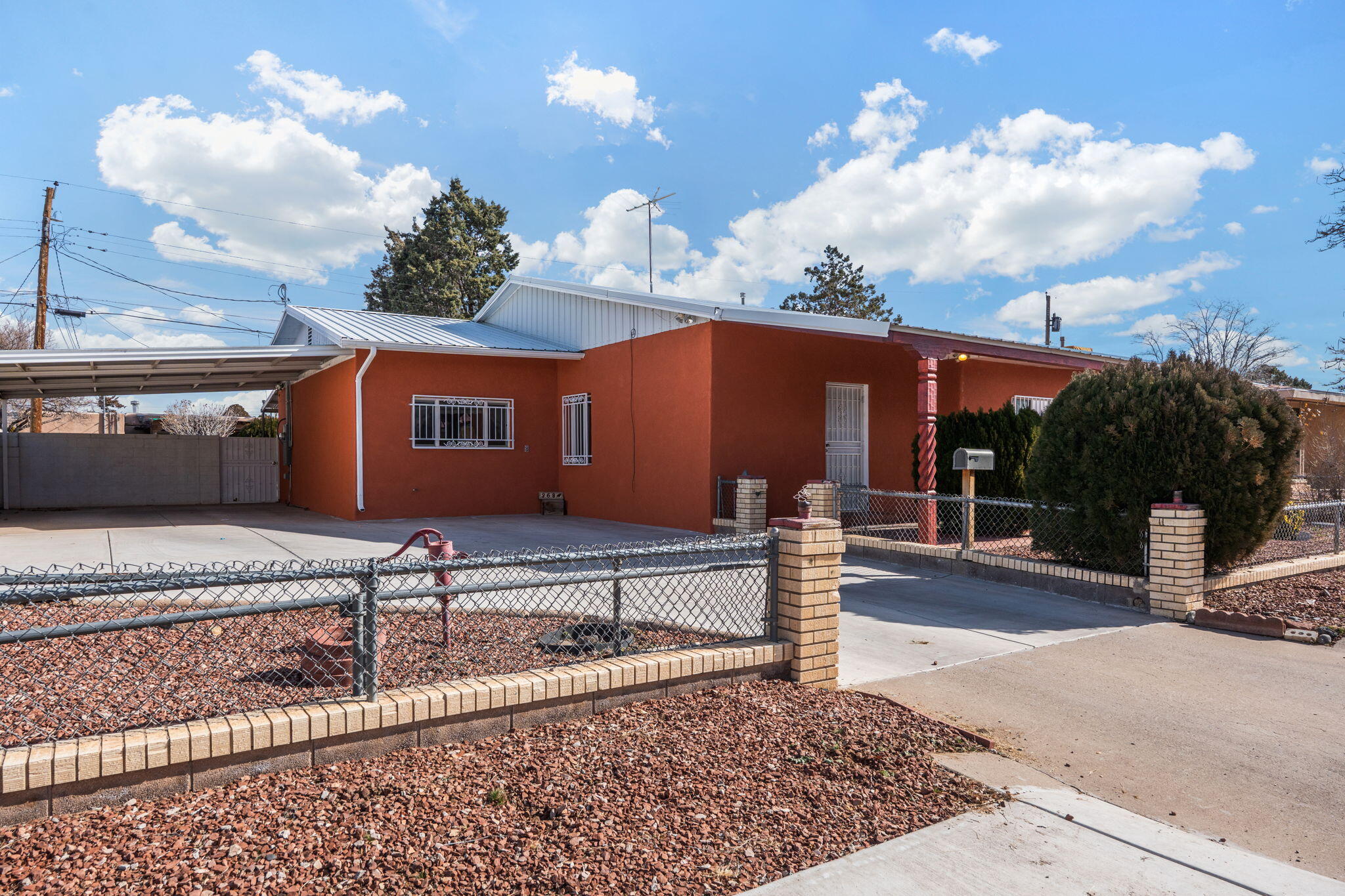 Welcome to this spacious and well-maintained Southwest-style home. This property features multiple living areas with tile and wood flooring throughout, and a functional layout ideal for everyday living or entertaining. The kitchen offers generous cabinet space, a breakfast bar, and easy access to dining areas. Bedrooms are comfortably sized, and the home includes ample storage, including built-in shelving. Enjoy outdoor living under the large covered patio, perfect for relaxing or hosting gatherings, with gated access and room to customize the yard. The home is equipped with refrigerated air for year-round comfort. Exterior updates include brand-new stucco completed in 2025, enhancing both curb appeal and durability. Conveniently located near shopping, dining, and major roadways.