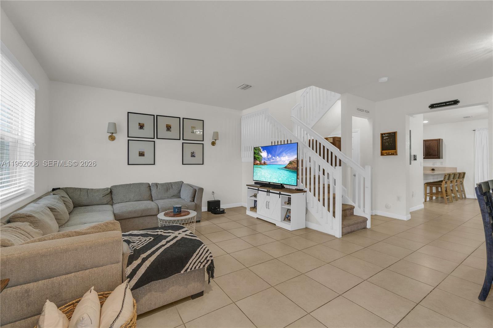 Welcome to this beautifully maintained two-story townhouse in the desirable gated community of Artesa in Homestead! Built in 2017, this spacious 3-bedroom, 2.5-bath residence offers 1,659 sq. ft. of comfortable living space with a functional and inviting layout. The first floor features tile flooring throughout and an open-concept design that seamlessly connects the living and dining areas, perfect for both everyday living and entertaining. The family room overlooks the updated kitchen, complete with dark espresso cabinetry, black stainless steel appliances, and an oversized counter ideal for casual dining and gatherings. Upstairs, enjoy a split-bedroom floor plan that provides privacy and comfort. The primary bedroom offers a walk-in closet and bathroom with a walk-in shower. The two additional bedrooms are well-sized and share a full bath. For added convenience, a new washer and dryer are located upstairs. Step outside to an attractive, low-maintenance backyard featuring a covered patio roof, elegant pavers, and turf and shed creating the perfect space for relaxing or entertaining year-round. Residents of Artesa enjoy resort-style amenities, including a clubhouse, pool, fitness center, playground, and tennis courts, all within a secure, gated community. Conveniently located near shopping, dining, schools, and major highways, this home offers the perfect blend of comfort, style, and lifestyle. Move-in ready and a must-see!