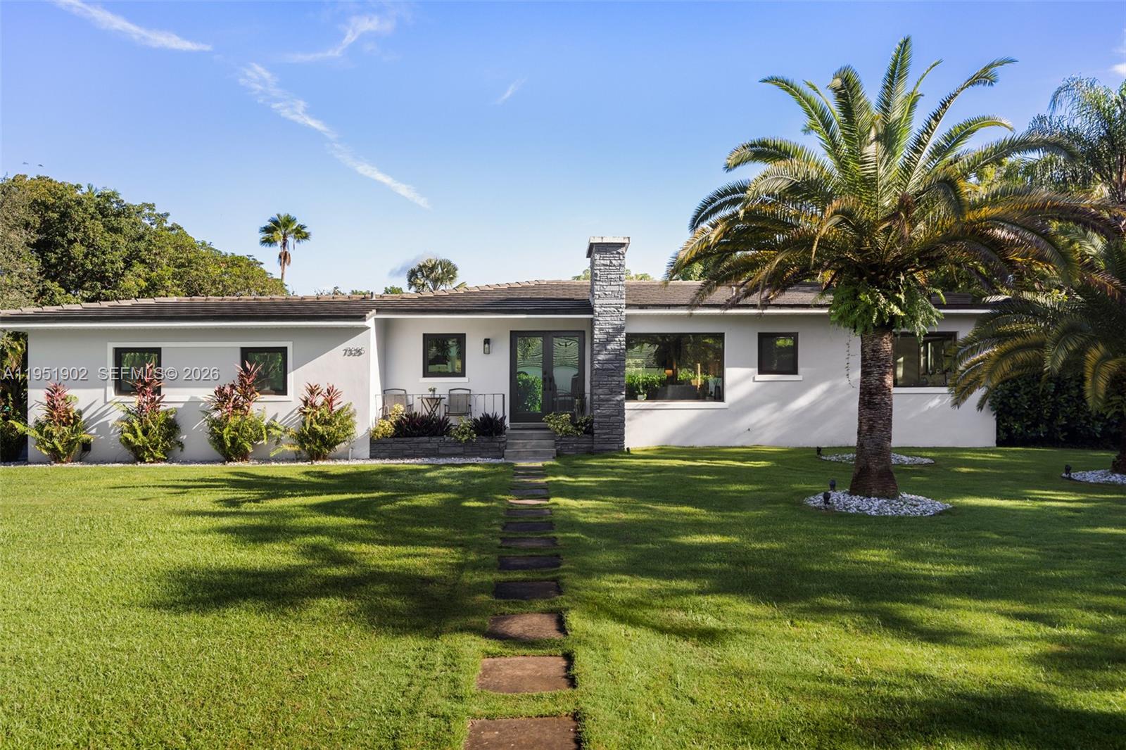 Set on over an acre in prestigious North Pinecrest, this exceptional property offers an increasingly rare opportunity to secure a park-like estate in one of the area’s most desirable and established residential neighborhoods, known for its estate properties, privacy, and top-tier schools. The grounds feature mature tropical landscaping, select fruit trees, and expansive open lawns, creating a serene setting and an exceptional sense of space, making it an ideal canvas for a future custom estate.Zoning allows for a secondary structure, enabling the addition of a guest house, home office, or other complementary use in support of the main residence. Existing infrastructure, including a natural gas connection, a full-house gas generator capable of supporting a larger residence, and an already-installed municipal water connection, adds meaningful value for future planning.The existing residence is light-filled and functional, offering flexibility while a future owner thoughtfully develops architectural plans and secures the necessary permits. Located within the highly sought-after Pinecrest school district, the property also benefits from convenient access to Dadeland-area amenities, Miami International Airport, and key commuter routes, combining a peaceful residential setting with easy everyday accessibility.