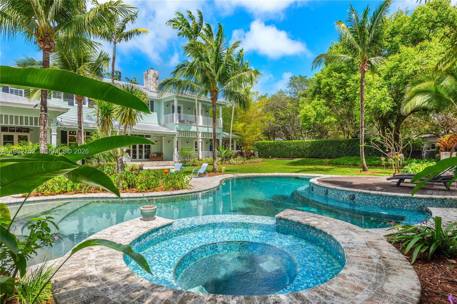 Located in the heart of Pinecrest on a picturesque 45,738 SF lot, this 7,763 SF Key West style home is a true sanctuary! Built in 2007, it features a spectacular & deep wrap-around porch that serves as outdoor living space, including a summer kitchen overlooking the resort-style pool. The welcoming floorplan has a double-height foyer entry w/ sweeping staircase, formal liv & din rms, office, chef’s kitchen w/ eat-in area, & spacious family room. Located on the 2nd floor, the primary suite has a private balcony, 2 walk-in closets, & a large bathroom including dual sinks, separate tub & shower, + vanity area. There are 6 add’l BRs & 5.5 more BA’s as well. With a 3 car gar, impact glass, generator, coffered ceilings, laundry room, & much more, this is the perfect place to call home!