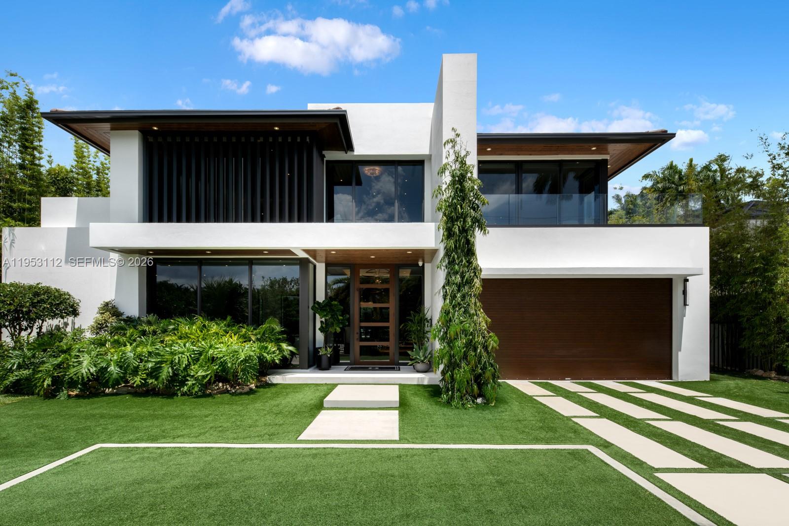 Architectural contemporary estate in the North of Pinecrest, completed in 2023 and set on an expansive canal-front lot offering more living area than shown on the tax roll. This 6-bedroom residence with 5 full and 2 half baths is a fully integrated smart home featuring a bespoke kitchen, statement bar, custom millwork, designer wall coverings, private elevator, and an oversized garage with car lift. The primary suite delivers a true wellness retreat with steam shower and sauna, while a dedicated theater elevates the entertainment experience. The outdoor oasis includes a covered pavilion, resort-style pool, and full pickleball/basketball court. Ideally positioned near top-rated schools, parks, and town centers, this is a standout offering in one of Miami’s most coveted neighborhoods.