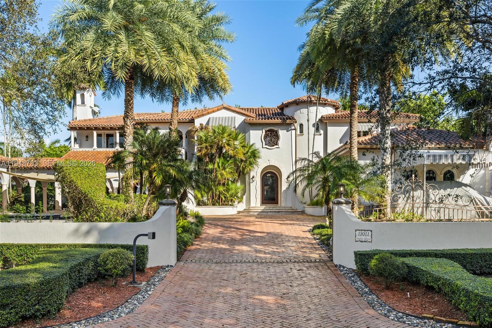 Stunning Spanish Villa in Exclusive Hammock OaksA rare opportunity to reside in the exclusive gated community of Hammock Oaks. This extraordinary Spanish-inspired estate offers ocean access and includes double boat slips and a 75-foot dock with water and electric, providing direct access to Biscayne Bay, perfect for boating enthusiasts.The home showcases soaring ceilings, marble and wood flooring, intricate millwork, and handcrafted stone and tile accents throughout. A chef’s kitchen with top-of-the-line appliances flows seamlessly into a spacious family and media room designed for both comfort and sophisticated entertaining. The custom bar area, complete with a designer ice machine, enhances the home’s exceptional entertainment spaces.Outdoors, lush tropical landscaping surrounds a resort-style pool and expansive entertainment areas, including a covered gazebo with built-in grill, half-court basketball and sports court. The property is also equipped with a mosquito repellent system, allowing for year-round outdoor enjoyment.A truly exceptional residence offering luxury, privacy, and the ultimate South Florida lifestyle.Additional highlights include:• Three-car garage with hydronic car lift• Additional covered parking• Central vacuum system• Permanent whole-house commercial-grade Generac generator with automatic transfer switch.