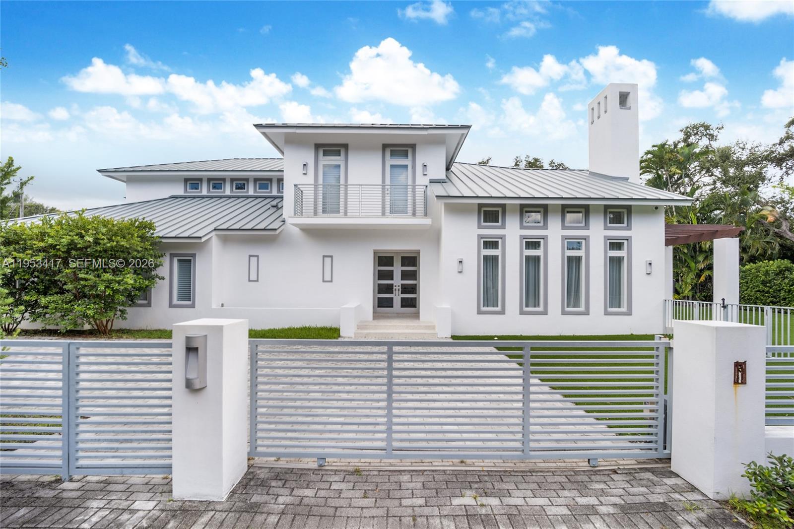 An exceptional executive home perfectly located in South Gables on a fully gated 15,000 sqft lot. Enter the ground floor through a light filled living area with double height ceilings and working fireplace. Large formal dining.  Large dining room leads an a eat in kitchen with oversized island with top of the line appliances. Ground floor  also features a huge family room and 2 bedrooms bothewith ensuite baths.  All rooms open to a sparkling tropical pool and large terrace, perfect for entertaining. The 2nd floor features an oversized primary suite with spa like bath and walk-in closet, a home office area and 2 bedrooms with ensuite baths all with balconies overlooking the pool. This gated home has a 3-car garage with huge driveway and plenty of room for parking.