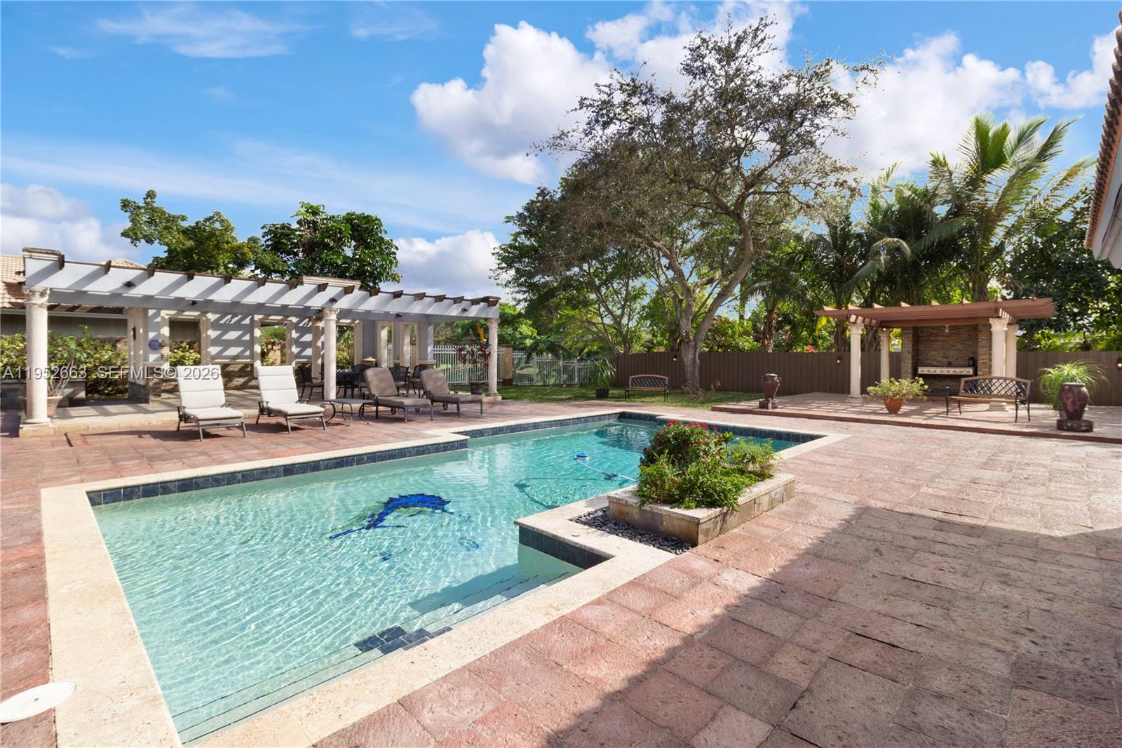 ONE OF A KIND!! THIS HOME HAS A LOT TO OFFER!! Rarely available spacious 5 bedrooms, 2.5 baths, 2 car garage, paved circular driveway single family home. Located on a large 20,266 SQF corner lot.A dream house with your private resort-style fenced-in oasis backyard. Perfect set up for family & friends  gatherings, & year-round outdoor South Florida living. Enjoy a full outdoor kitchen, BBQs, three charming gazebos spacious paved sitting area ideal for lounging or dining, sparkling large heated pool. Spacious open kitchen totally updated in 2020, wood cabinets, granite counter tops, features premium KitchenAid stainless appliances. Wall oven, new refrigerator, lots of cabinets & counter top space convenient to prepare for a family feast. Kitchen opens up to a spacious dining room with custom bar. Enjoy an open and family entertaining room! Spacious 4 bedrooms + den, split floor plan w/ a large master wing on its own side w/ private bathroom with Jacuzzi tub & shower. Tile flooring throughout. Laundry room with custom cabinetry. Bright open floor plan with lots of natural light, vaulted ceilings that deliver an open spacious feel throughout. Pool 2016, Pool water heater 2023. All impact windows & doors done in 2015. Sold furnished w/ some exclusions. Great location in a desired Coral Springs neighborhood close to schools, shopping & dining. This home combines luxury, functionality, & Florida lifestyle at its finest. Don't miss this rare opportunity.Schedule your showing today!