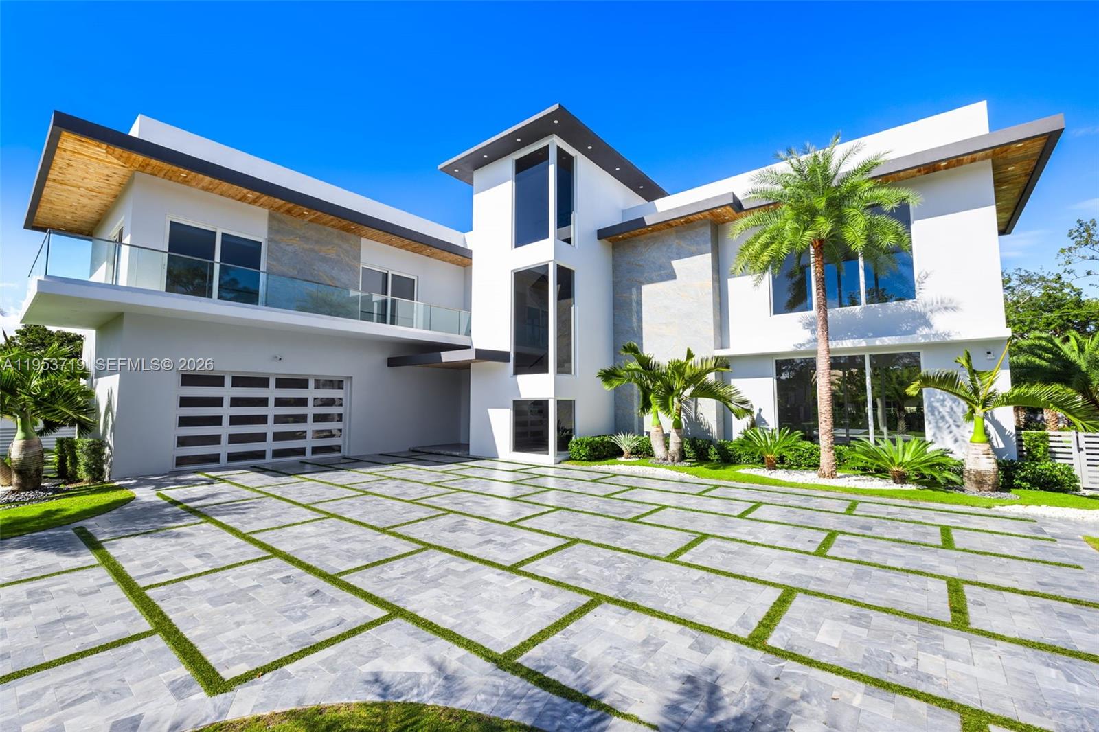 A recently completed modern residence offering refined scale, architectural clarity, and thoughtful design throughout. This home features five en-suite bedrooms plus a powder room, with soaring two-story ceilings anchoring the kitchen, entry, and primary entertaining spaces to create an immediate sense of volume and light.Walls of expansive impact glass frame the outdoors and flood the interiors with natural light, while the open, well-proportioned floor plan is designed for seamless living and entertaining. The kitchen and main living areas flow effortlessly to the exterior, where a glistening pool, lush grassy yard, and private sports court create a true indoor-outdoor lifestyle.The outdoor spaces are thoughtfully layered, featuring a poolside entertaining area with a covered summer kitchen. A rooftop sundeck, complete with a secondary grill, offers generous space to tailor the setting for open-air dining, lounging, and entertaining under the stars.A detached cabana/guest suite offers flexibility for guests, work, or recreation. The property is moments from the bay, with coastal breezes and a tranquil setting that enhances everyday living.Located in one of the most desirable neighborhoods of Palmetto Bay, this is a turnkey modern home defined by scale, light, and quality, ideal for those seeking a refined yet relaxed South Florida lifestyle.