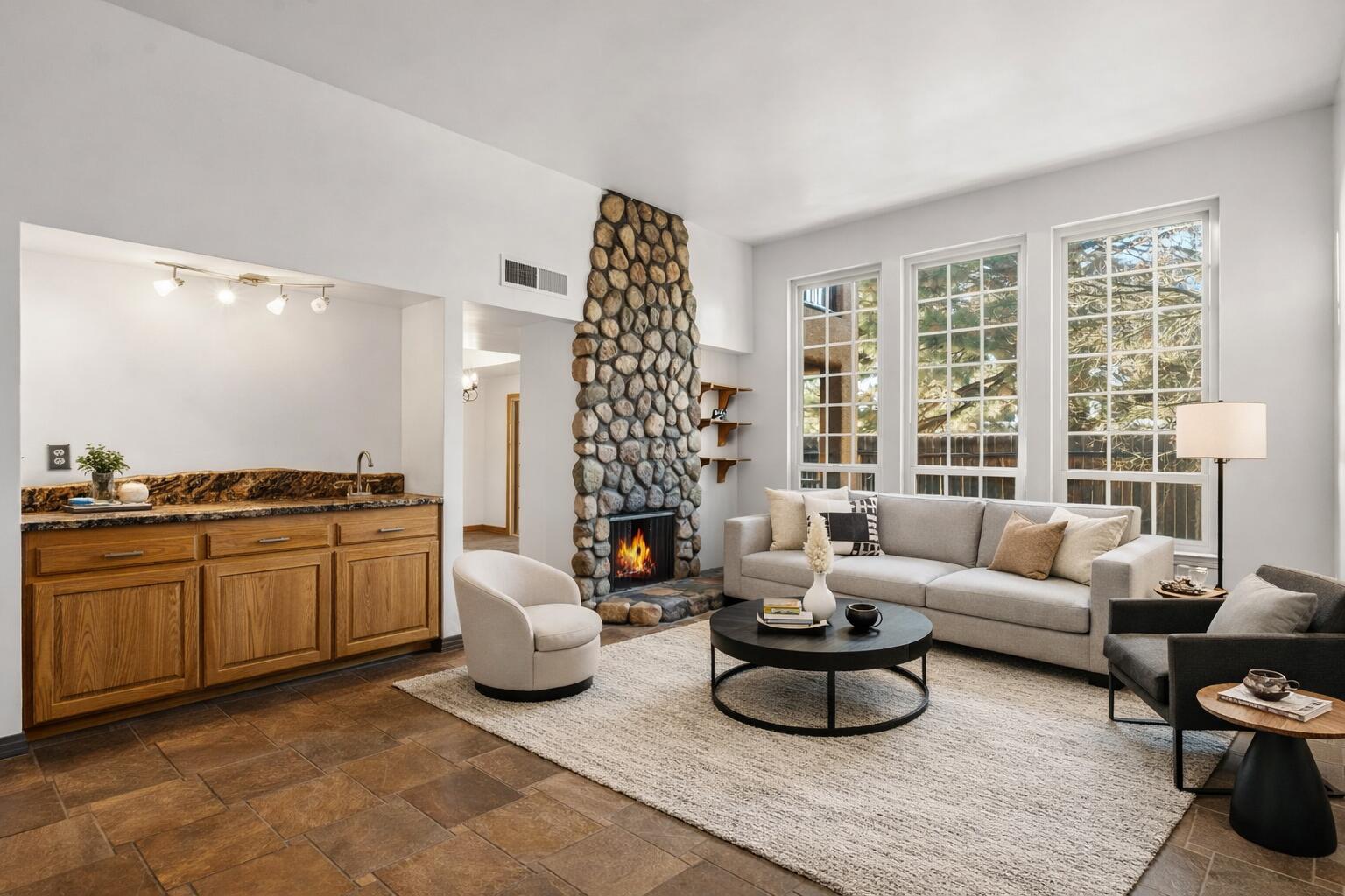 BRAND NEW Refrigerated air unit installed. Located in the desirable Chimney Ridge community, across from Arroyo del Oso Golf course. This beautifully updated 4 bedroom town-home features a main-level primary suite w/ a full bathroom, living room with it's own fireplace, wet bar, & built-ins. The kitchen showcases granite counter-tops, stainless steel appliances, a breakfast nook, bar seating, & a spacious pantry. Upstairs, a large den or optional fourth bedroom with its own fireplace opens to a balcony with serene views of the pool and clubhouse.  Freshly painted. The HOA provides exceptional value, covering the roof, stucco exterior, water, trash service, and community amenities such as a swimming pool, tennis courts, and clubhouse. Close to restaurants, golf, shopping, & m