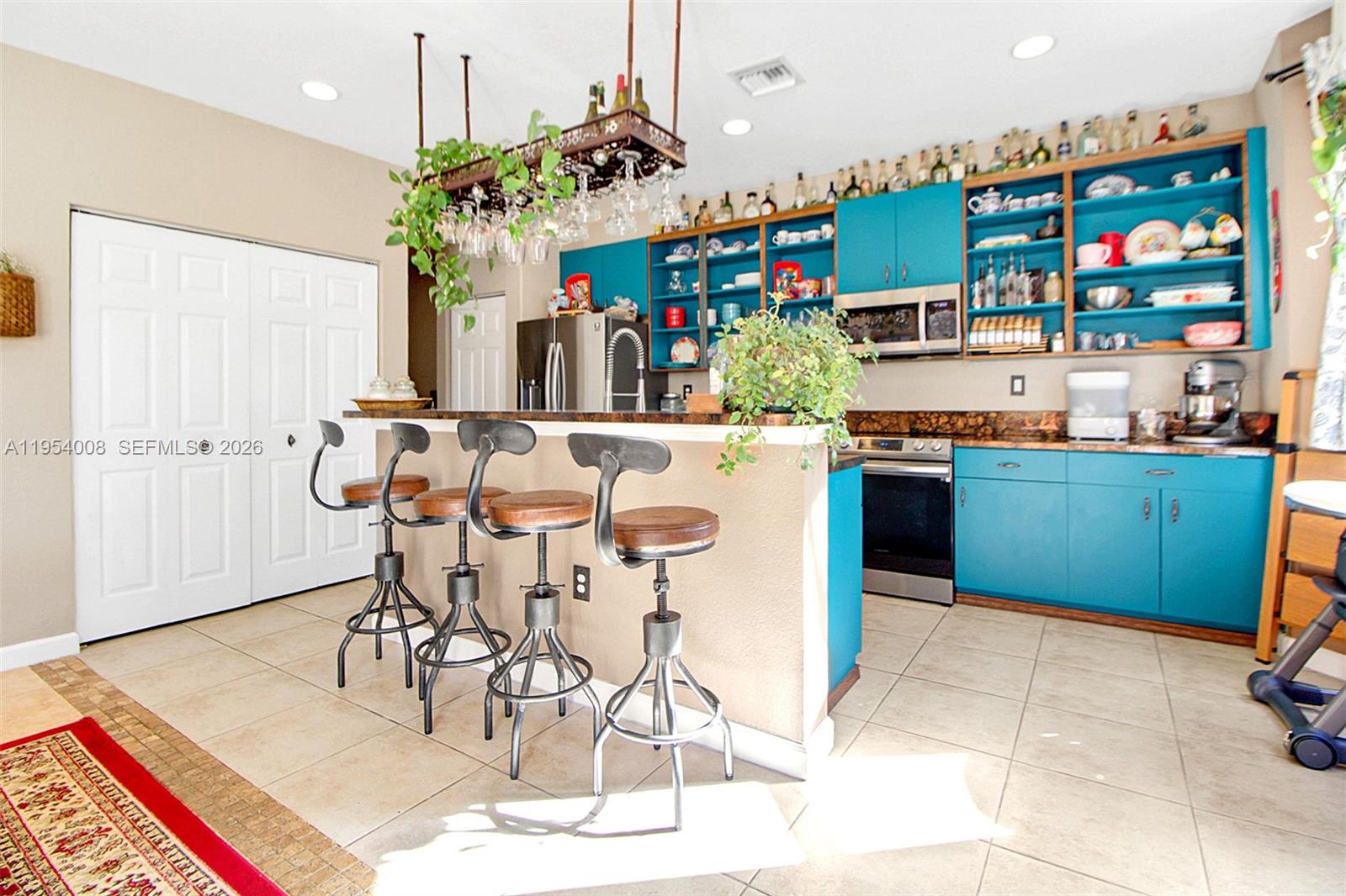 Tastefully curated 2-story residence offering 2,786 Sq.Ft. of living space in the desirable Keys Landing community. Featuring a convenient ground-level bedroom and full bath—perfect for in-laws, guests, or teens. The open-concept layout showcases tile and laminated wood flooring, a spacious family room, parlor room, and an open kitchen with wet bar, ideal for entertaining and everyday living.Upstairs includes 3 additional bedrooms and 2 full bathrooms, highlighted by a private primary suite featuring two walk-in closets and a spacious ensuite bath with separate shower and soaking tub, plus extra flex space in the second-floor corridor. Situated on a 5,971 Sq.Ft. lot with room for a pool. Energy-efficient solar panels help reduce electricity costs. Impact windows on the second floor and storm panels on the first provide added peace of mind.Complete with a 2-car garage, separate laundry room off the kitchen, and a prime location near parks, schools, shopping, dining, and quick access to the Florida Turnpike.