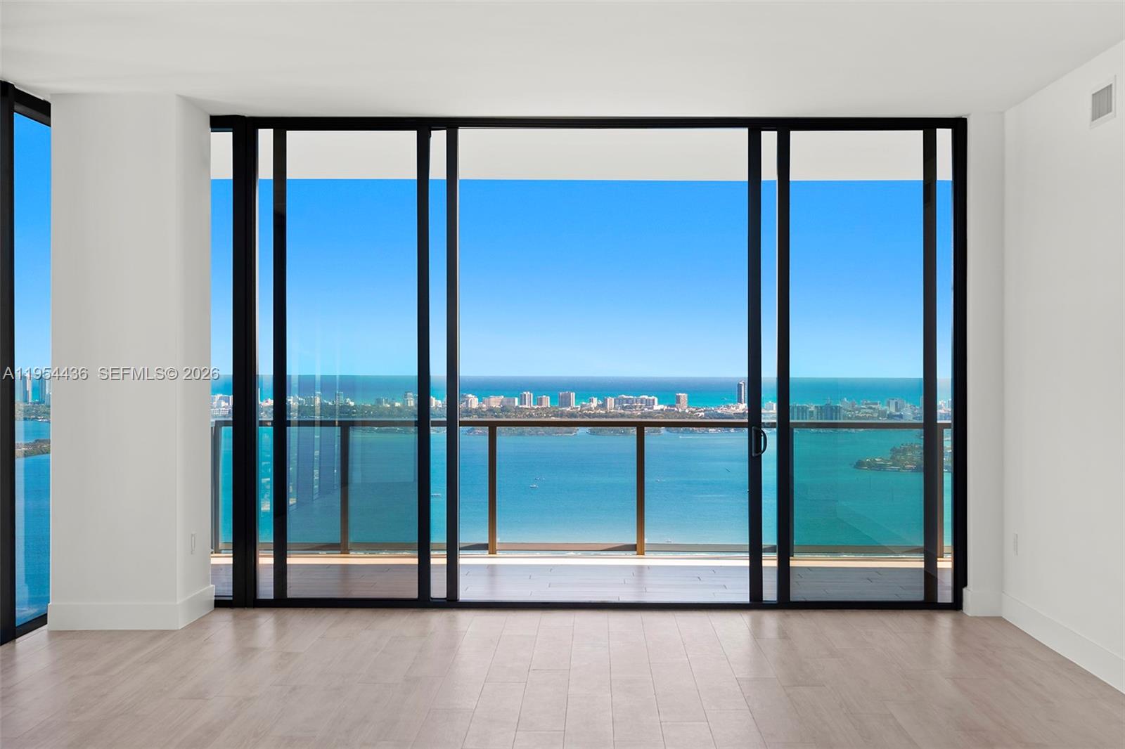 Located on the 55th floor of Elysee, this flow-through residence enjoys panoramic views from sunrise to sunset. Floor-to-ceiling glass and an east-to-west layout create a light-filled interior with open sightlines throughout. The living room, kitchen, and east-facing terrace overlook Biscayne Bay and the Miami Beach skyline, while the west-facing terrace offers expansive sunset and city views.The residence is accessed via a private elevator and foyer and features 4 bedrooms, 4.5 bathrooms, and a spacious den. The primary suite includes floor-to-ceiling windows, a spa-style bathroom with a large soaking tub, custom marble shower, and an oversized walk-in closet.The kitchen is thoughtfully designed for both daily use and entertaining, featuring Italkraft cabinetry, Wolf and Sub-Zero appliances, and a gas cooktop. Well-proportioned living spaces and refined finishes provide comfort, functionality, and flexibility.Building amenities include sunrise and sunset pools, a state-of-the-art fitness center, a private owner’s lounge on the 30th floor, a children’s playroom, valet service, and 24-hour concierge. Offering privacy, generous living space, and full-service amenities, this residence is ideally positioned in one of Edgewater’s premier waterfront buildings.