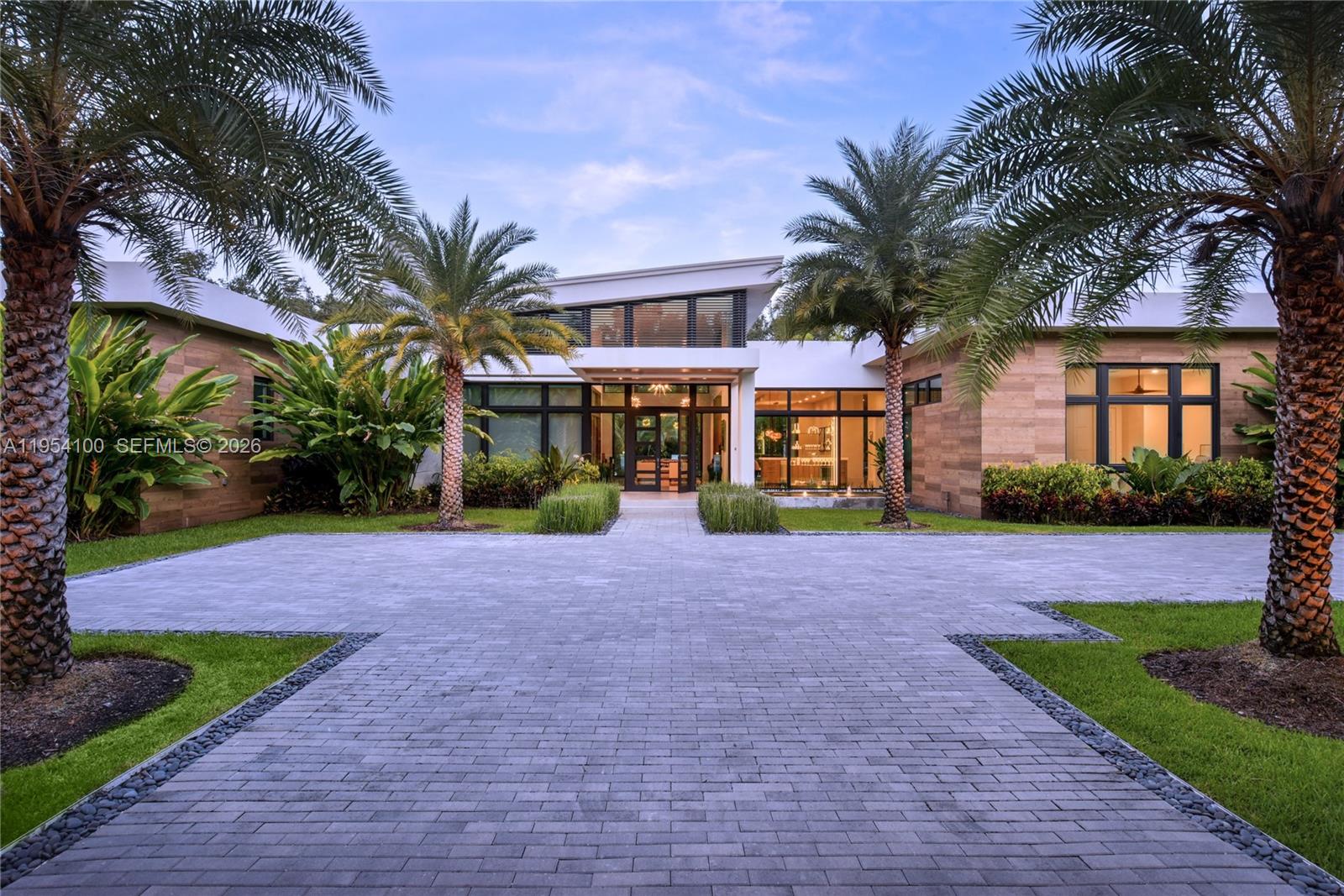 A rare offering combining architectural integrity, modern luxury, and creative functionality !  A 2019 one-story Hollub custom built residence, offering 5 bedrooms and 5 bathrooms on a quiet, beautiful street in North Pinecrest. Thoughtfully designed with clean lines, warm materials, and seamless indoor-outdoor flow, this home is ideal for both everyday living and sophisticated entertaining.The interiors feature remarkable entertaining spaces, including a fully built-out private theater, a dedicated study, gym with sauna and  a professional recording studio that can be easily converted into an additional bedroom and bathroom, offering flexibility for evolving needs. Every space reflects meticulous attention to detail, with top-tier finishes, refined design, and exceptional craftsmanship throughout.Outdoors, lush landscaping frames a resort-style pool and inviting entertainment areas, creating a private oasis perfect for gatherings or quiet relaxation. The home also features a bar, expansive living areas, and effortless circulation between interior and exterior spaces. Generator!!Designer furniture may be included, offering a truly turnkey opportunity.