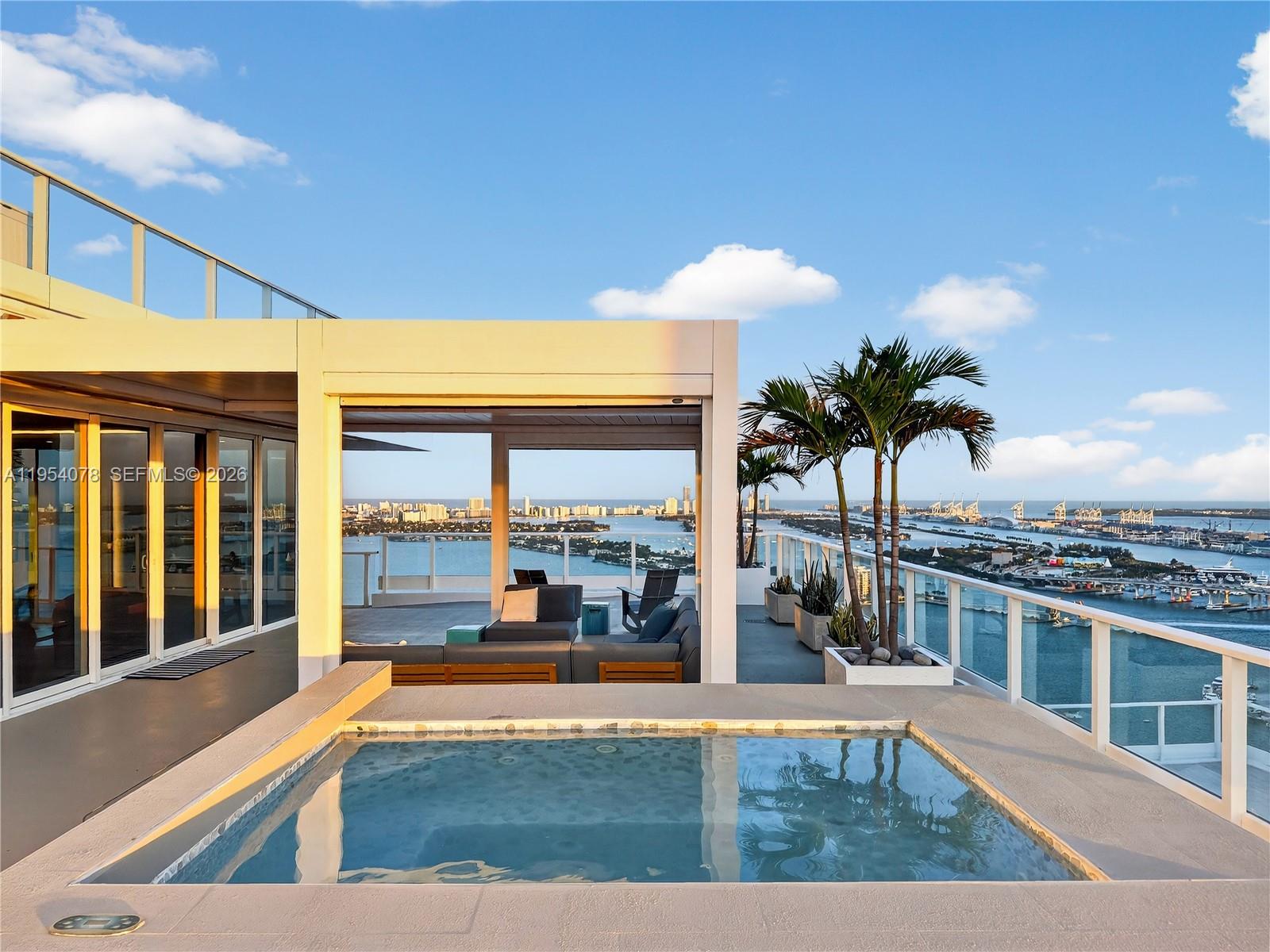 Don’t miss out on this rare opportunity to own a true trophy penthouse at Paramount Bay offering breathtaking panoramic views of Biscayne Bay, the Atlantic Ocean, & the Miami skyline. This expansive residence features an exceptional indoor-outdoor lifestyle w/more than 2,200 SF of terrace, ideal for entertaining & sunset dining. It has been extensively renovated with a modern, elevated design, featuring 10 ft floor-to-ceiling glass, linear diffusers, dropped & lit ceilings, & seamless flow. The sleek modern kitchen showcases oversized Sub-Zero refrigerator/freezer, full size wine fridge, 2 Wolf ovens, built-in coffee maker, island top Wolf range, & custom cabinets open to generous living & entertaining spaces flooded w/natural light. The primary suite is a spa-like retreat with stunning water views, walk-in closet, luxurious ceiling mounted rainfall shower, soaking tub, & dual vanity. A private rooftop terrace with a built in plunge pool, pergola, and outdoor kitchen sets this residence apart as one of the most luxurious penthouses in Miami. Resort quality amenities include 2 pools w/towel service, whirlpool, cabanas, & BBQs; fitness center w/weights, cardio, pilates reformer equipment, instructors, massage, steam room, & sauna; kid/teen rooms; billiards; banquet rooms; conference rooms; & comprehensive onsite staff, front desk services, maintenance, & valet parking. Enjoy close proximity to Margaret Pace Park, Design District, Wynwood, & Miami Beach!