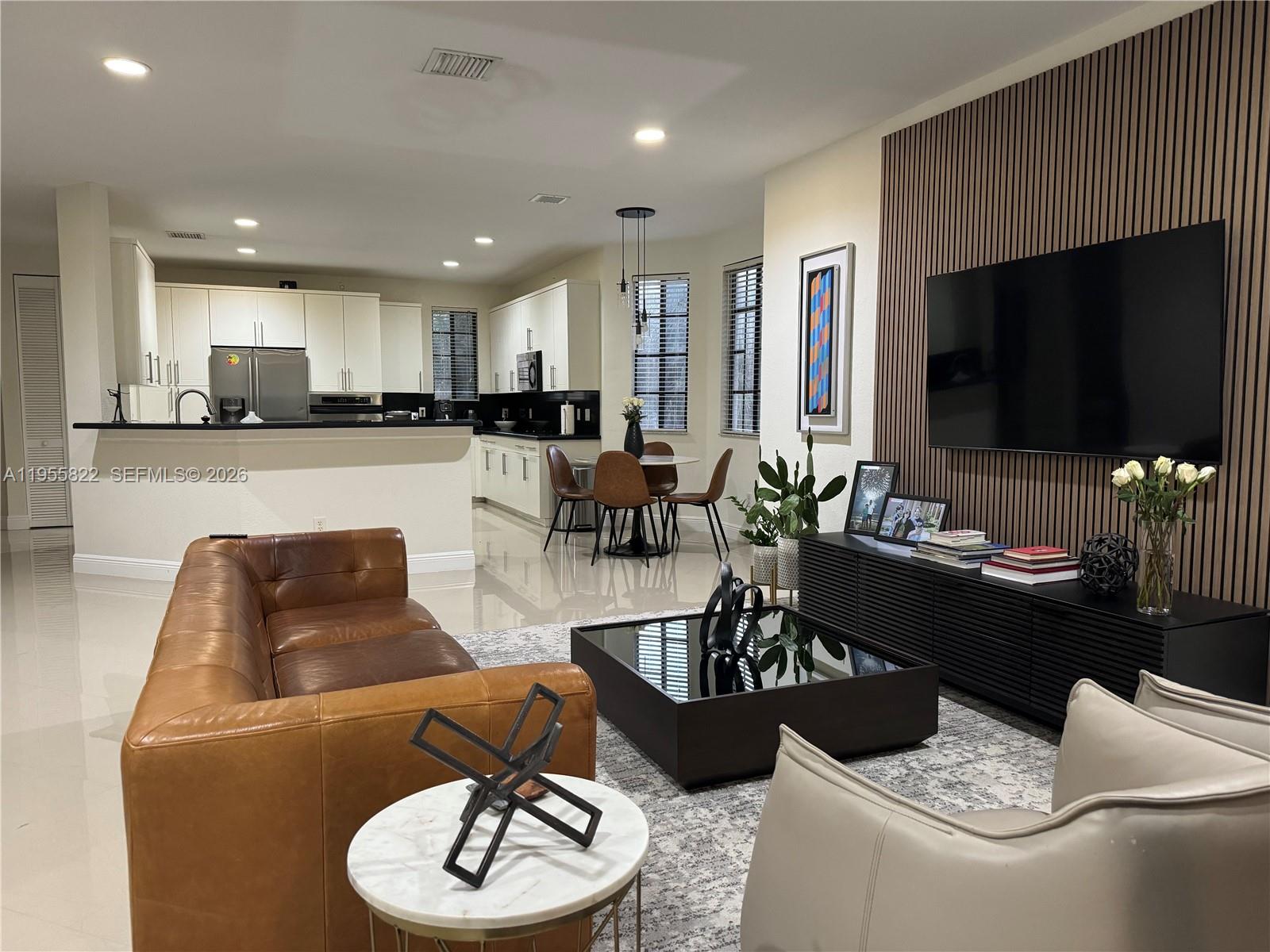 Beautifully upgraded 4-bedroom, 2.5-bath home located in the heart of Weston, within walking distance to Weston Town Center. Situated in the desirable gated Mariposa community, this spacious residence features a Triple-split floor plan offering privacy and functionality. Interior highlights include tile and wood laminate flooring throughout, upgraded kitchen,  and abundant closet space.The primary suite offers a large en-suite bath and generous walk-in closet. Enjoy indoor-outdoor living with a large screened balcony/patio, perfect for relaxing or entertaining, and a charming courtyard-style entrance.Additional features include a 2-car garage with large driveway, laundry room, and a brand new roof providing extra peace of mind. The association covers exterior maintenance, roof, painting, insurance, landscaping, and security. Ideally located across from The Club at Weston Hills, close to A+ schools, shopping, dining, and major highways.