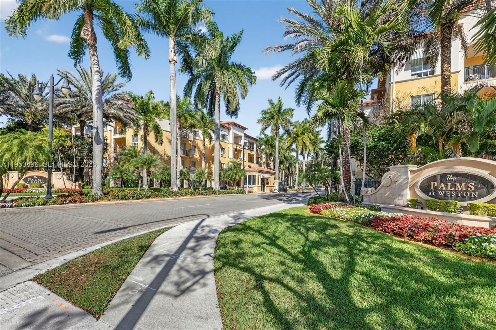 Welcome to this coveted first-floor corner residence in the highly sought-after, guard-gated 55+ community of Palms at Weston – Island House. This spacious 2-bedroom, 2.5-bath condo offers serene lake views and the rare convenience of its own private balcony gate with direct access to the pavered walking paths & resort-style amenities. Kitchen features wood cabinetry, new marble countertops & backsplash, new stainless-steel appliances, and a spacious eat-in area. Open layout showcases crown molding, recessed lighting, fresh paint, and neutral tile flooring throughout the main living areas, with new laminate flooring in both bedrooms. Impact glass windows and doors. The primary suite includes a walk-in closet w/ built-ins, double vanity, separate shower, and a relaxing jacuzzi tub. Additional highlights include a newer washer/dryer, water heater & A/C replaced in 2019. Enjoy luxury amenities including a resort-style pool and 2 spas, fitness center w/ sauna & steam room, clubhouse, library, beauty salon, on-site restaurant, concierge services, card room, complimentary valet and on-site health care agency. Maintenance fees include internet/cable, water, trash, and a $180 quarterly restaurant credit. An exceptional opportunity to enjoy comfort, convenience, and an active lifestyle in one of Weston’s premier communities. Fantastic location - close proximity to Cleveland Clinic, major highways, Publix & many restaurants.