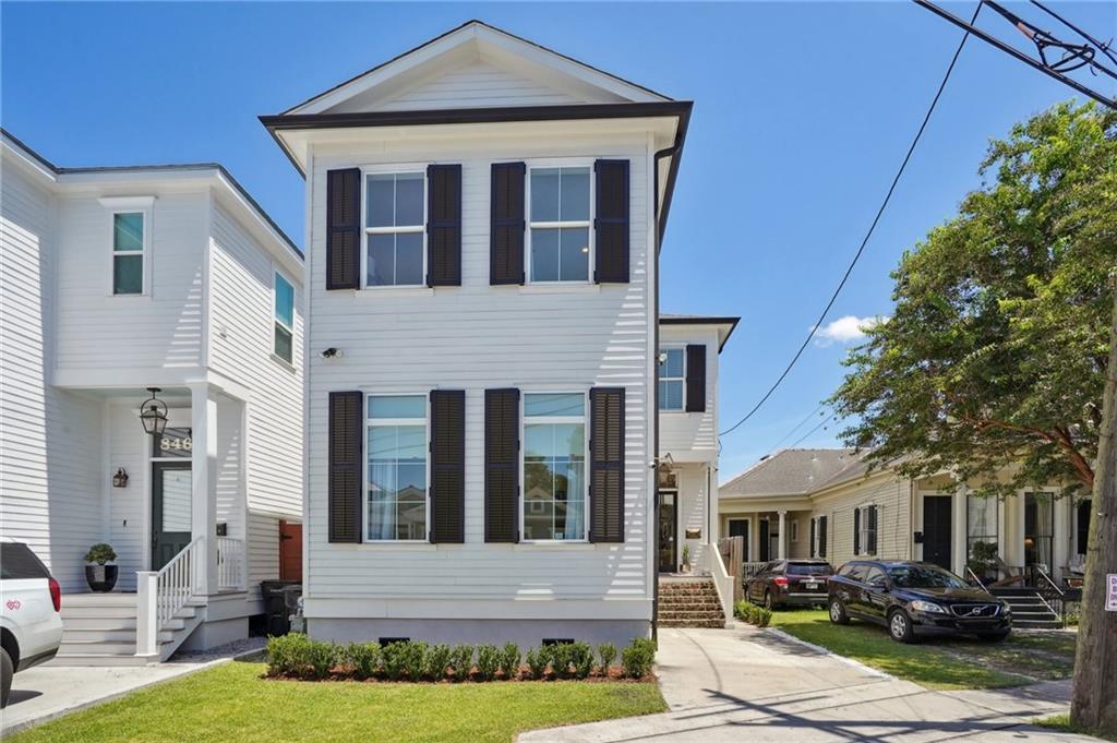 Discover this exquisite designer home, built in 2019, nestled in the vibrant Parkview neighborhood. Just steps away from Bayou St. John, City Park, the Streetcar, Jazz Fest, this property offers an unparalleled lifestyle in one of the city's most desirable locations. An inviting front porch greets you with a Bevolo gas lantern & wood ceiling detail. The open concept offers a spacious kitchen and living area boasting 11 ft ceilings, wood floors throughout, and a seamless flow that's perfect for entertaining. The gourmet kitchen is a chef's dream with a large island that provides seating for four, stainless Thermador appliances, gas range, quartz countertops, and a walk-in pantry. Elegant living adorned with coffered ceilings, a gas fireplace, and french doors that open to the covered back patio. Luxurious primary bedroom is bathed in natural light, with a spa-like bathroom including a soaking tub, spacious shower with glass surround, double vanity sinks, and a unique cypress door entry. Two primary closets, including a spacious walk-in closet designed for a true fashionista. Two more bedrooms upstairs, connected by a Jack & Jill bath setup. A fourth bedroom option if needed is located on the main level that can live as part of the house, or it may serve as a potential rental income option with an exterior entry, living area, wet bar, and full bathroom, pick the ideal lifestyle option to fit your needs. Previous income of $1,800 a mon. The backyard has a custom turf that’s perfect for game day gatherings, with ample space to cheer on the Saints. Convenient off-street parking completes this perfect package. Steps from the Endymion Mardi Gras parade route. This home is the epitome of luxury and comfort, offering a unique blend of modern amenities and timeless charm. You'll be smitten.