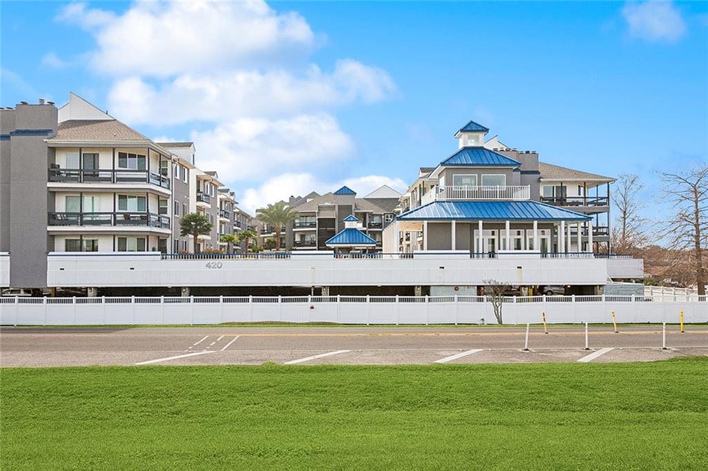 We invite you to experience premier, condominium living in this bright and open, updated loft-style condo on the scenic  Lakefront. Enjoy Lake views and stunning sunsets from your primary bedroom and private balcony!!  This unit offers a spacious, airy layout.  Primary bedroom on main floor with huge walk in closet. Kitchen offers granite counters and stainless steel appliances (brand New Refrigerator and Microwave). Loft/second bedroom is upstairs with its own private full bathroom.Enjoy resort-style amenities including a clubhouse, sparkling pool, soothing hot tub, and a relaxing gazebo. There's gated access throughout the property, a reserved covered parking spot next to elevator, and private storage unit.  Once you go up the elevator, you will encounter a short flight of stairs to the unit.  Conveniently located within walking distance to restaurants and activities Bucktown has to offer including Bucktown Harbor Park!