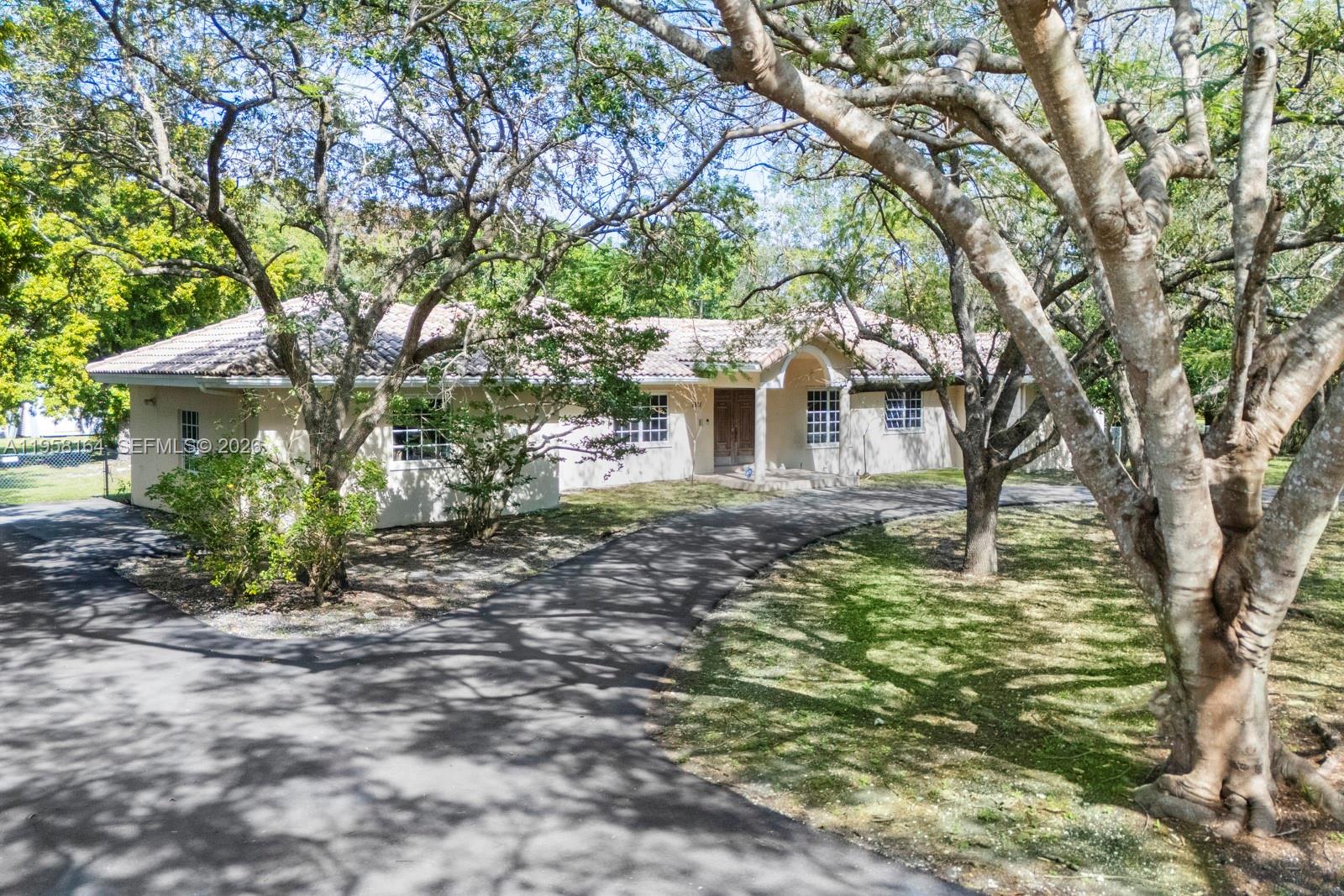 Opportunity Knocks!  Beautiful and expanded family home located on a fantastic acre on a quiet low traffic Pinecrest street.  Original house modified and enlarged in the 90s and includes high ceilings, large primary suite, huge kitchen-family area, and is a full 5-bedroom home.  Oak-laden front yard with  expansive driveway and very secluded and lush perimeter in the back.  Ideal opportunity for end user or investor...renovation or knock down.  Centrally located with great schools and easy access to all! The possibilities are endless.