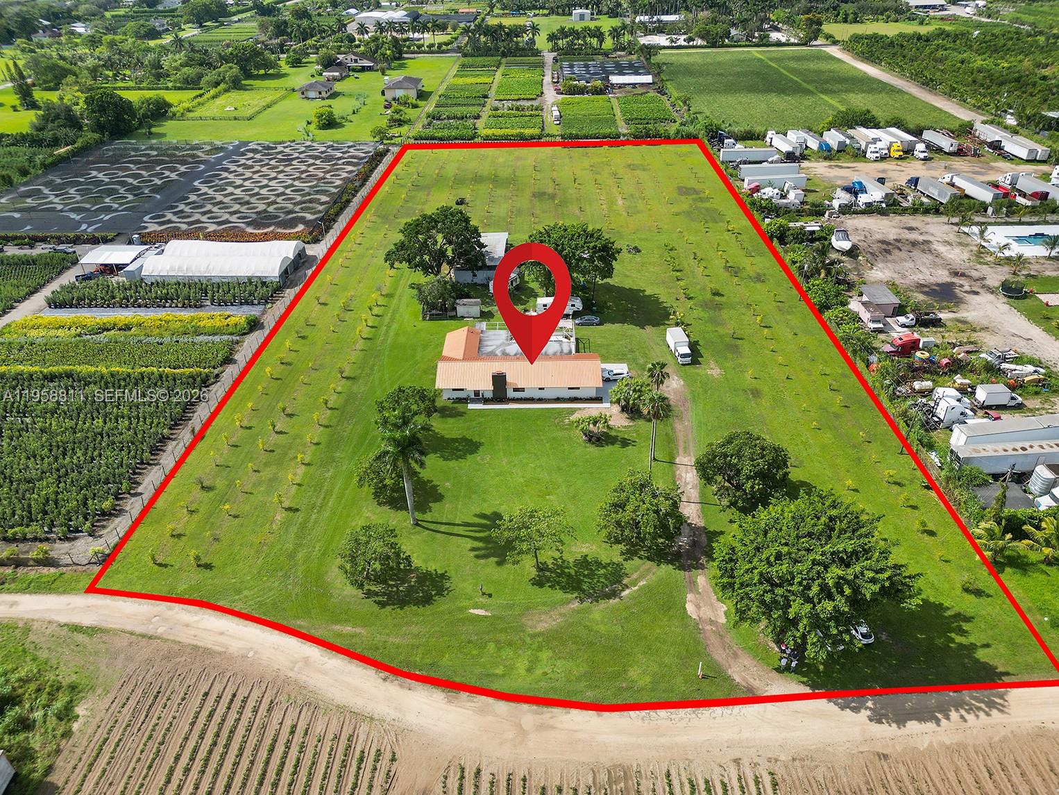 Peaceful and Private nearly 5 acres of land in the heart of Redlands, most of which is a lime grove. This expansive parcel offers endless potential and true agricultural charm, complete with a spacious 40x60 pole barn ideal for equipment, storage, or future projects. An RV pad with sewer and electrical hookups adds additional functionality to the land. Enjoy peaceful country living surrounded by nature, with minimal light pollution allowing for breathtaking night skies and stargazing. This quiet retreat is just a short drive from Miami’s vibrant lifestyle and the scenic route to the Florida Keys—offering the perfect balance of seclusion and convenience. The sale of the land includes a custom-built 1980s home with 4 bedrooms and 2 bathrooms. Recent upgrades feature a newer metal roof, impact windows and doors, and two new A/C units. The open-concept living area includes a spacious kitchen flowing into the main living spaces and a fireplace. Motivated seller. Schedule your showing today.