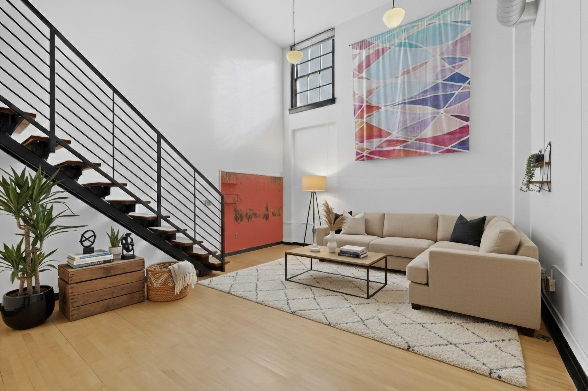 Live in a true piece of Albuquerque history in this light-filled two-level loft inside the iconic 1938 Gymnasium building at The Lofts at Albuquerque High. Positioned on the southeast corner, this approximately 1,238 sq ft home features large operable south- and east-facing windows, original wood floors, and an open living space anchored by an island kitchen with full appliance package. Two full baths and a full-size washer and dryer add everyday comfort. Enjoy elevator access, a fitness room, and a secure, beautifully landscaped courtyard with grill and fountains. Just steps from downtown shops, dining, entertainment, and transit. HOA covers water, sewer, trash, and recycling. Two pets allowed. No Air Bnb