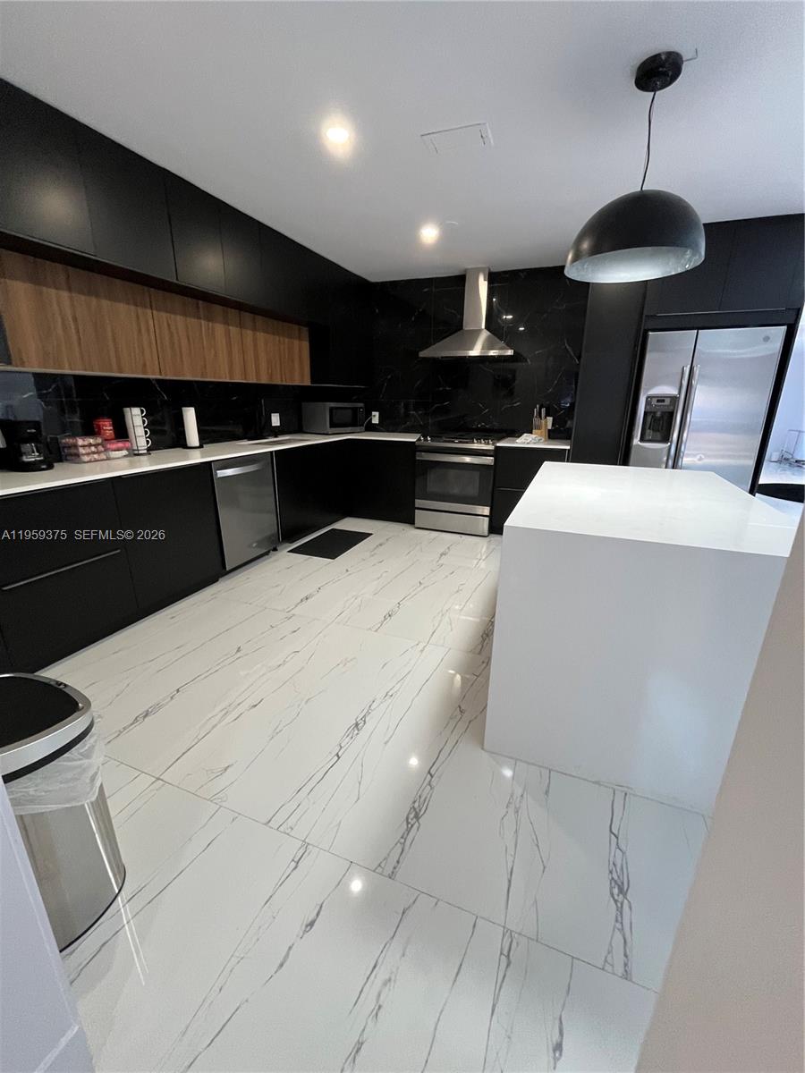 Modern kitchen with designer features at 39 7th St - Home in Dania Beach