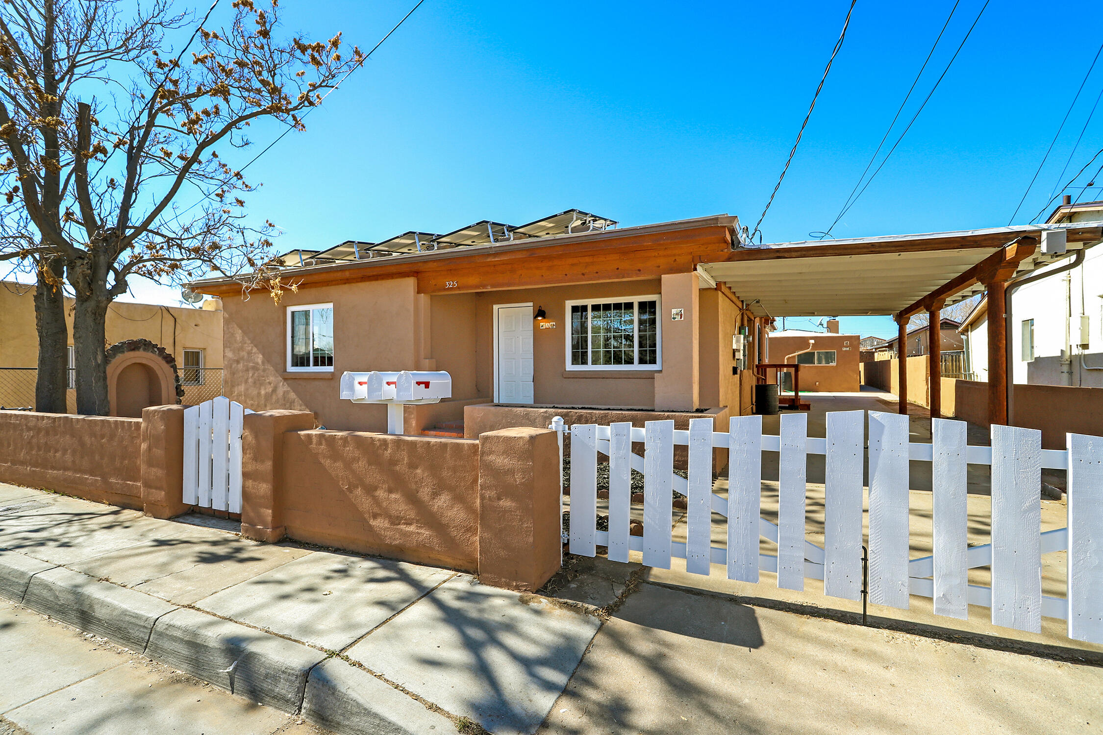 Imagine yourself living near the heart of Old Town, where evening strolls through the Plaza, Christmas lights, and cozy romantic dinners become part of your everyday rhythm. This beautifully updated triplex feels less like an investment property and more like a true home--featuring a spacious 3-bed, 2-bath front residence, plus two private 1-bed retreats behind, perfect for extended family, guests, or rental income that helps pay the mortgage. Fireplaces, bonus rooms, built-ins, and dedicated laundry make every space feel intentional. With owned solar, thoughtful upgrades including hot water heaters, flooring, appliances, kitchens, baths, and circa-2019 TPO roof and mini-splits.  Owner-occupied financing available, this is a rare opportunity you may feel grateful you discovered.