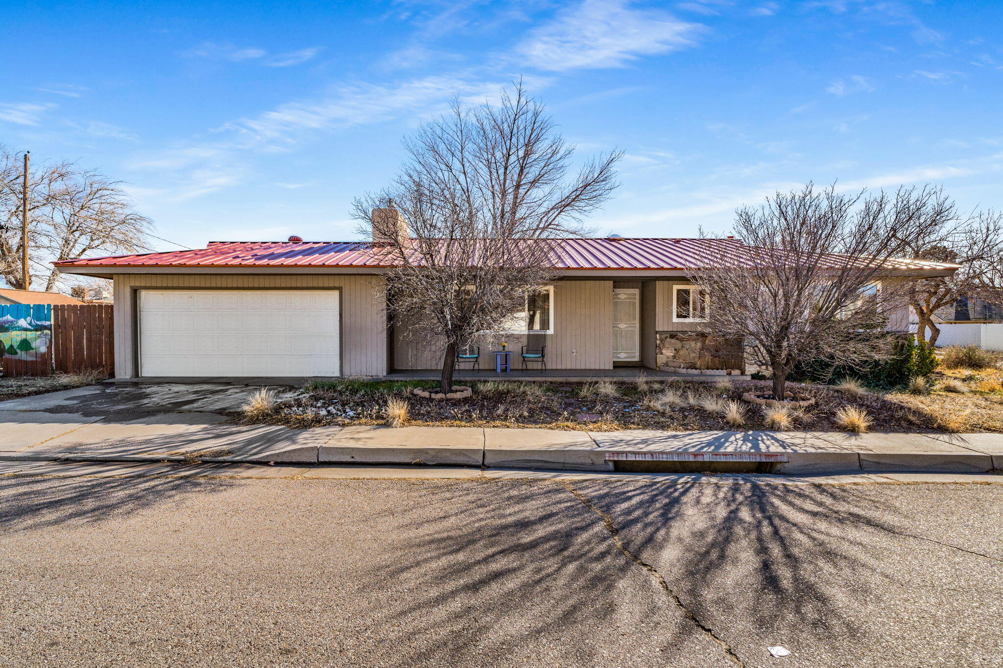 You're invited to discover this charming, energy-efficient corner-lot home featuring a metal roof& 2019 solar panels--fully paid off by seller at closing for added buyer savings! Features include refrigerated air, newer water heater, updated 200-amp electrical panel, security screen doors, & double-pane vinyl windows. Original hardwood and tile flooring run throughout, while the kitchen offers a marble baker's countertop, gas stove, and ample cabinetry. Enjoy a cozy gas fireplace and a spacious backyard with a shed, dog run, garden area, rainwater capture system, and mature fruit trees. The home also includes a crawl space for easy plumbing access. Conveniently located within walking distance to Vista Verde Park, minutes from Trader Joe's, and with quick access to I-40. This one won'