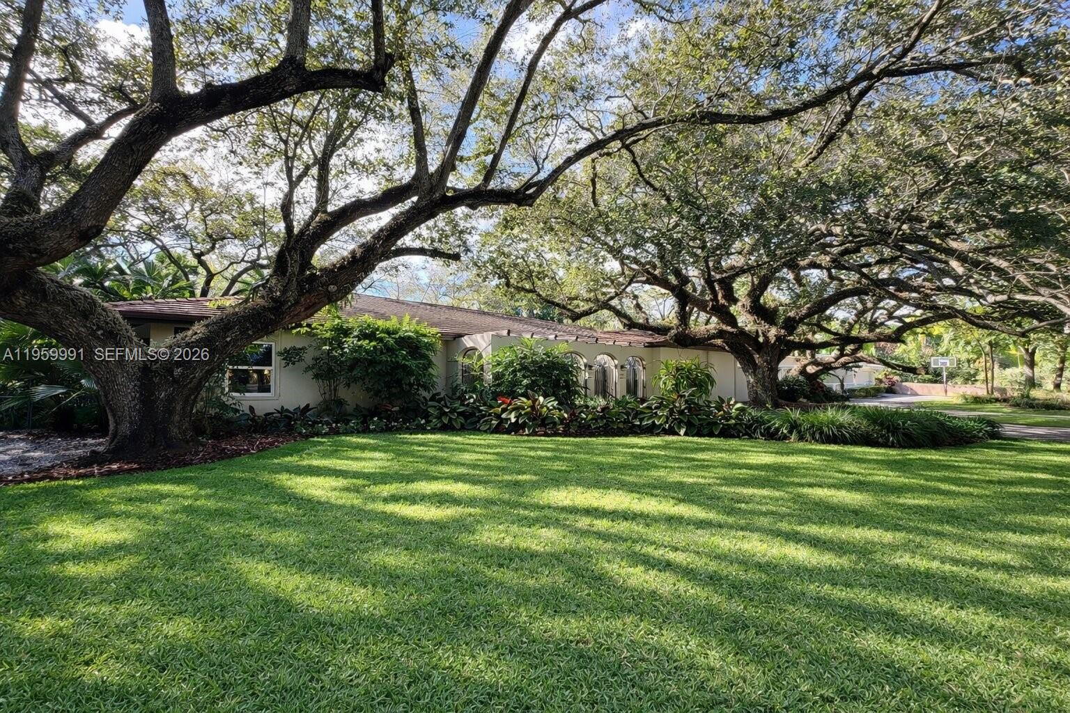 Secluded under tall oaks & lush landscaping, you'll find this newly renovated home on 12,000+ sq.ft. lot. The 4 bedroom 2 1/2 bath features eat-in kitchen with Quartz countertops and Stainless Steal appliances. All new flooring and impact windows and doors. Large primary bedroom with walk-in closet. Screened in covered patio with ample space for entertaining and overlooks expansive lush backyard. Large 2-car garage. Quiet neighborhood with minimal traffic. Great location in the heart of Coral Gables.  Minutes away from downtown Coral Gables, Coconut Grove, South Miami and the airport.