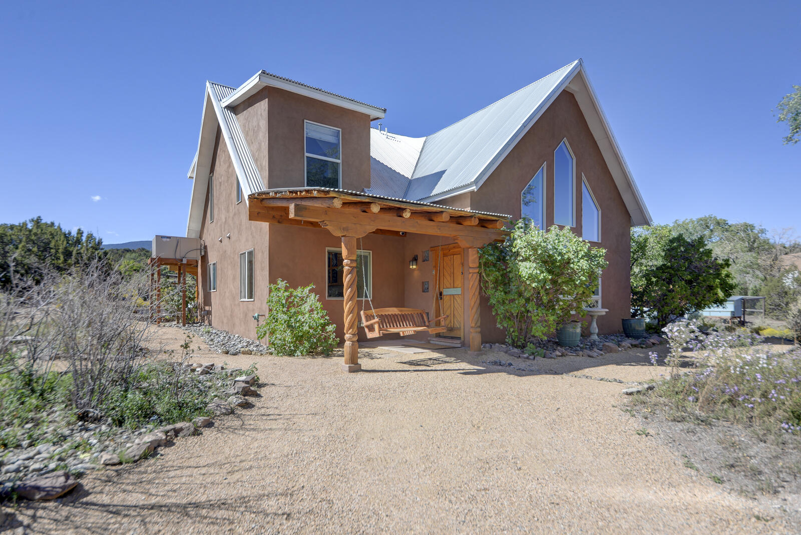 OPEN HOUSE: SATURDAY FEBRUARY 14th 12-3PM.Welcome to this charming custom Northern New Mexico-style home, tucked in a peaceful valley at the foothills of the Montezuma Ridge. The open layout w/ soaring cathedral ceilings create a bright, airy feel throughout. The beautifully remodeled kitchen features quartz countertops, a dual-fuel ProBake convection oven & custom cabinetry throughout the home!  With no HOA & designated horse property you'll enjoy your freedom & creativity.The historic land is dotted with reminders of early Native residents, gold and silver miners, giving the property a truly unique sense of place.A spacious 2-car garage (20'X30') includes a 10'X20' workspace, perfect for hobbies or storage. Two, 1-acre vacant lots akin to the property also FOR SALE!