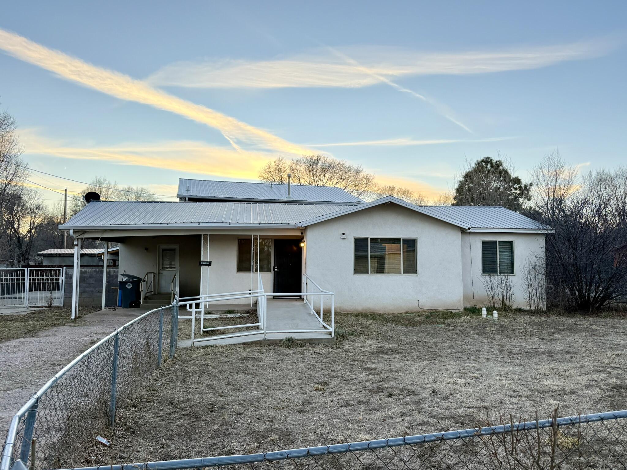 BIG VALUE, GREAT LOCATION, AND ENDLESS POSSIBILITIES IN LAS VEGAS, NM! Set on a spacious corner lot in a quiet neighborhood, this 3-bedroom, 1-bath home is a great FTHB opportunity or investment rental. Features include natural gas, central heat furnace, pro-panel roof, concrete accessibility ramp, carport plus ample parking, and full city utilities. Located near I-25 with easy access to Highlands University, the historic Plaza, local dining, and daily essentials. Outdoor recreation including hiking, birding, and nearby lakes adds to the lifestyle appeal, while Santa Fe is an easy drive away. Easement allows rear-side maintenance access. Affordable, well-located, and full of potential. Schedule your showing today! *Property has a zero-lot line/no backyard. SQFT is approx. Buyer to verify.
