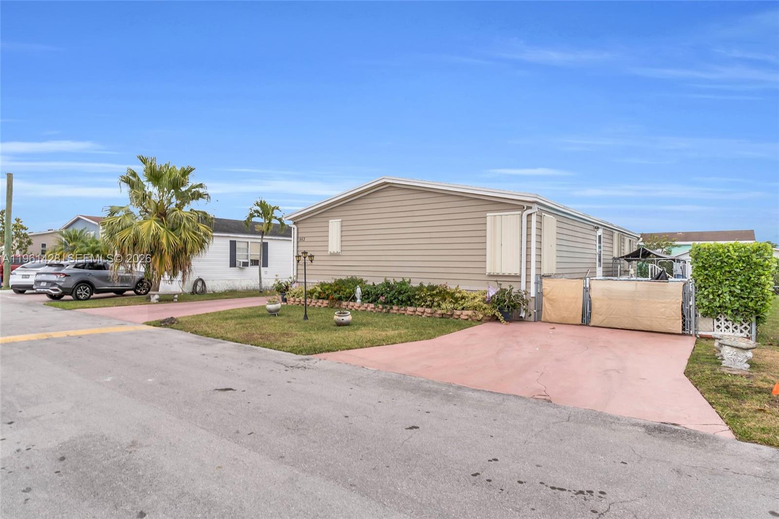 Charming and move-in ready 3br/2BA double wide home built in 2007 with Land included in the sought-after Americana Village Community and low HOA. Highlights include a partially new roof (1 year old), solar panels, new laminated flooring, and a beautifully rebuilt front porch ( 1.5 years old) . Major systems are in great shape with a 5 year old A/C and water heater. Enjoy outdoor living with a 16.5' x 10' above ground pool, exterior accent lighting, and a ring security system with 3 cameras.