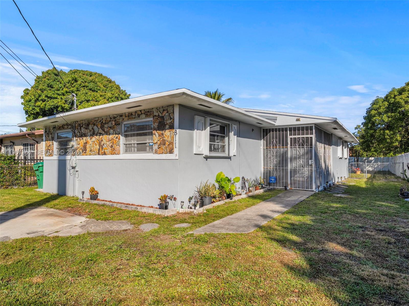 Rare opportunity near Biscayne Park and Miami Shores. Four-bedroom, two-bathroom home in a rapidly growing Miami area, just minutes from Barry University. Features spacious layout, oversized backyard with concrete pad, functional kitchen and separate laundry/pantry room. Enjoy a rear attached storage room offering endless possibilities for conversion. AC system is only few years old. The 4th bedroom can easily be converted to an in-law quarters. Fully gated for added privacy and security. Conveniently close to i95, Gratigny Parkway and Downtown Miami. This is a great entry level home for buyers looking to enter the Miami market.  Incredible potential in one of Miami's up-and-coming areas. Easy showings.