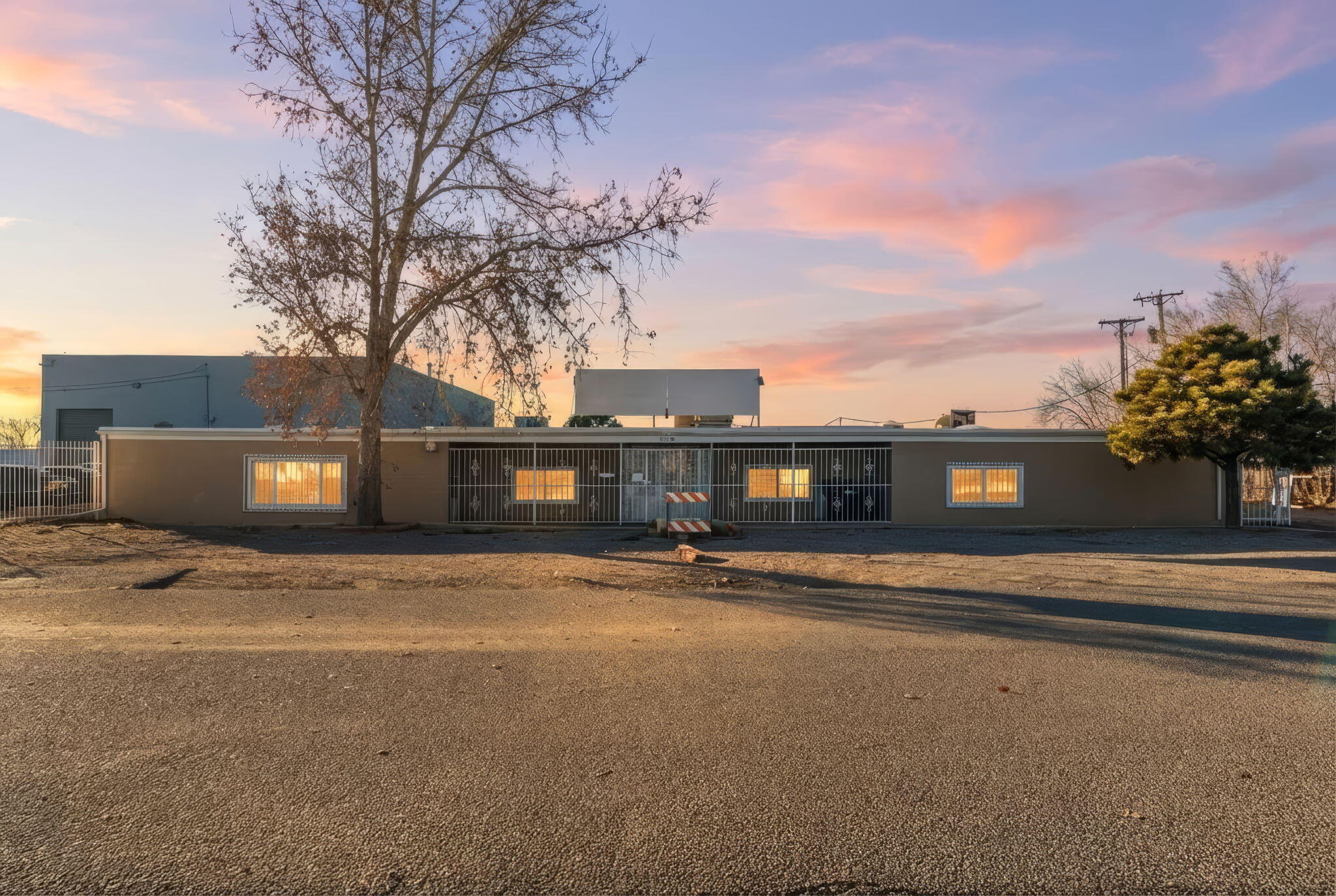 Rarely does a M-1 commercial property of this caliber and versatility become available in the heart of Albuquerque. This expansive 5,357sq ft property delivers outstanding versatility with three warehouse spaces, a secure vault, and flexible office/living areas totaling approximately 2,325+/- sq ft. Designed to support both productivity and comfort, the property features a pond, pool, hot tub, RV site with dump, ample parking, and a dedicated loading and unloading area. Privately situated on a quiet street yet strategically located with convenient access to the Big I, this distinctive property seamlessly blends business functionality with lifestyle amenities--ideal for enterprises seeking space, security, and adaptability. Owner Financing offered!