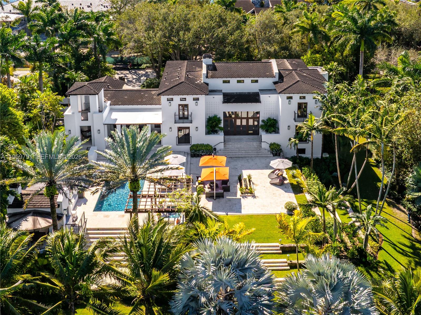 Welcome to 555 Arvida Pkwy- a stunning Mediterranean AND Modern estate on over an acre in coveted Gables Estates! Renovated from top to bottom in 2015, this 6 bedroom, 6/2 bath residence offers 13,147sf of resort-style living space on three levels.  A yachtsman's paradise, with 180ft of frontage (w/ 100ft dock & boat lift), it can easily accomodate multiple vessels. Beautiful modern interiors include soaring ceilings, large windows, a billiard room with spectacular see-through aquarium wall to an office/study, 5000-bottle wine cellar/tasting room, and a chef's kitchen adjacent to a large family room with ample bar seating. On the lower level, you'll find an expansive gym (with full bath and sauna), huge playroom, theater, and 2-bedroom staff quarters alongwith ample flex space for storage and other uses.  Garage parking for 5+ cars and an elevator. Approved plans to expand are available. This is one of only 24 homes in all of Gables Estates with exclusive access to the private Leucadendra tennis courts, making this your own private country club! Furniture available separately (all artwork, wine, and personal property excluded). Seller-financing available.  555 Arvida is, by far, the best value move-in condition home in all of Gables Estates!