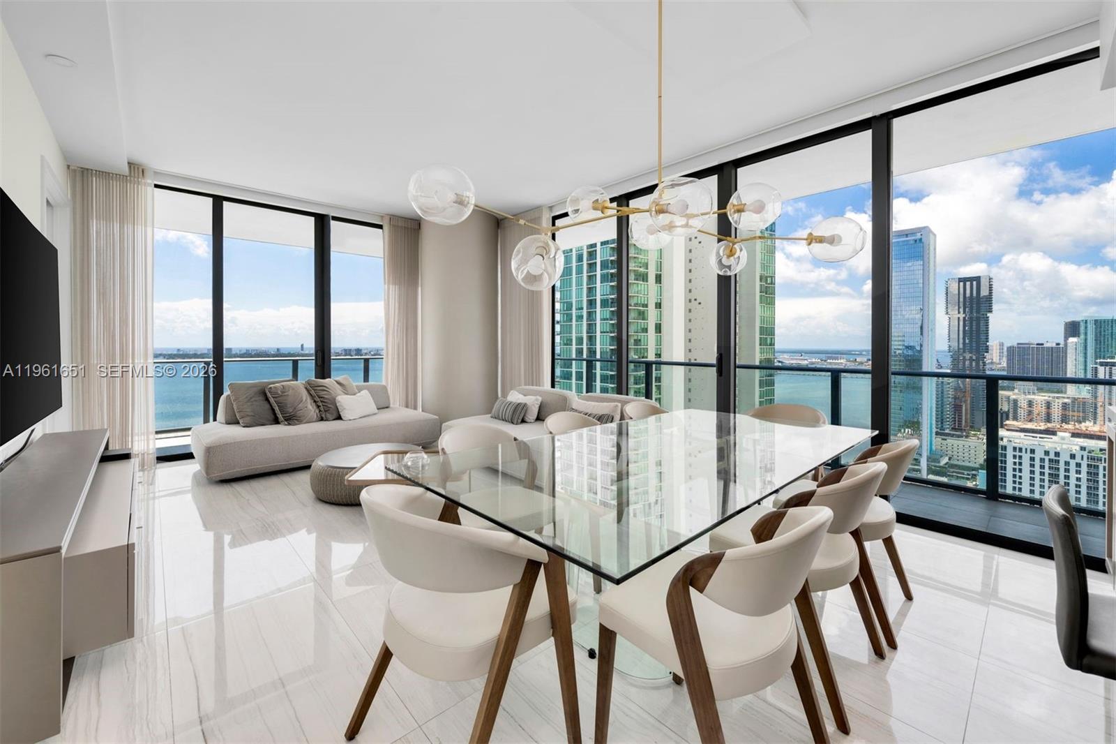 Experience unparalleled luxury and sophistication in this exquisite 4-bedroom, 4.5-bath turnkey residence at Gran Paraiso, set on a premier waterfront location. Natural light floods the interiors through dramatic ceiling-height glass panels, creating a bright and inviting ambiance throughout. Step onto the expansive 8-foot-deep terrace and take in breathtaking panoramic views of Biscayne Bay and the Miami Beach skyline—perfect for relaxing or entertaining.The unit has been completely remodeled with extensive upgrades and is truly move-in ready. Located in the heart of Edgewater, Gran Paraiso offers exceptional convenience with easy access to Miami International Airport, Coral Gables, South Beach, and Coconut Grove, while being moments from dining, shopping, and cultural destinations.