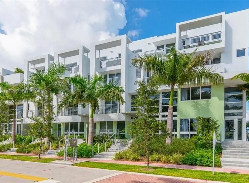 Modern 4-Story Townhome at Iris on the Bay. Built in 2019, this 3BR/3.5BA townhome features a full-floor office, 4 walk-in closets, spacious living room, laundry room, and 2-car garage. Enjoy a rooftop terrace + 3 balconies with stunning park & downtown views. Impact windows/doors, bright interiors, private elevator and very low HOA. Gated community with pool; boat slips available. Walk to the beach, golf, dining, tennis, pickleball, playgrounds & more! Easy to show.