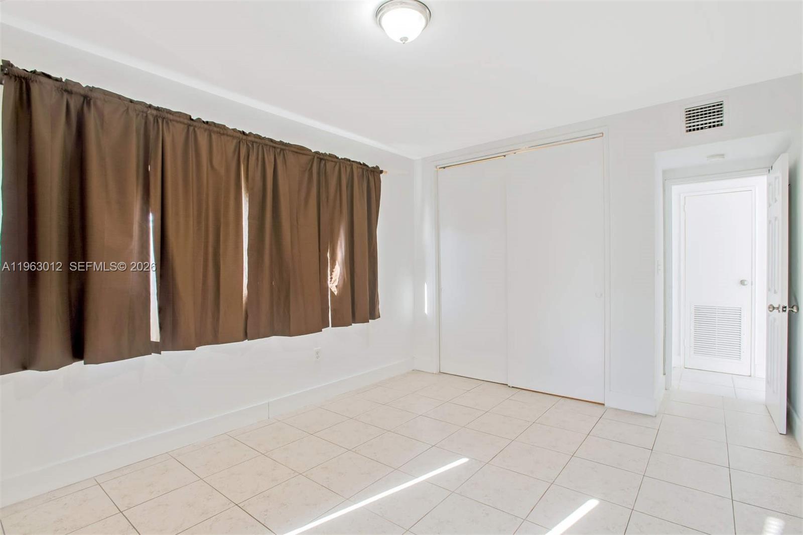 Well-appointed guest bedroom at 10001 Bay Harbor Dr - Condo in Bay Harbor Islands