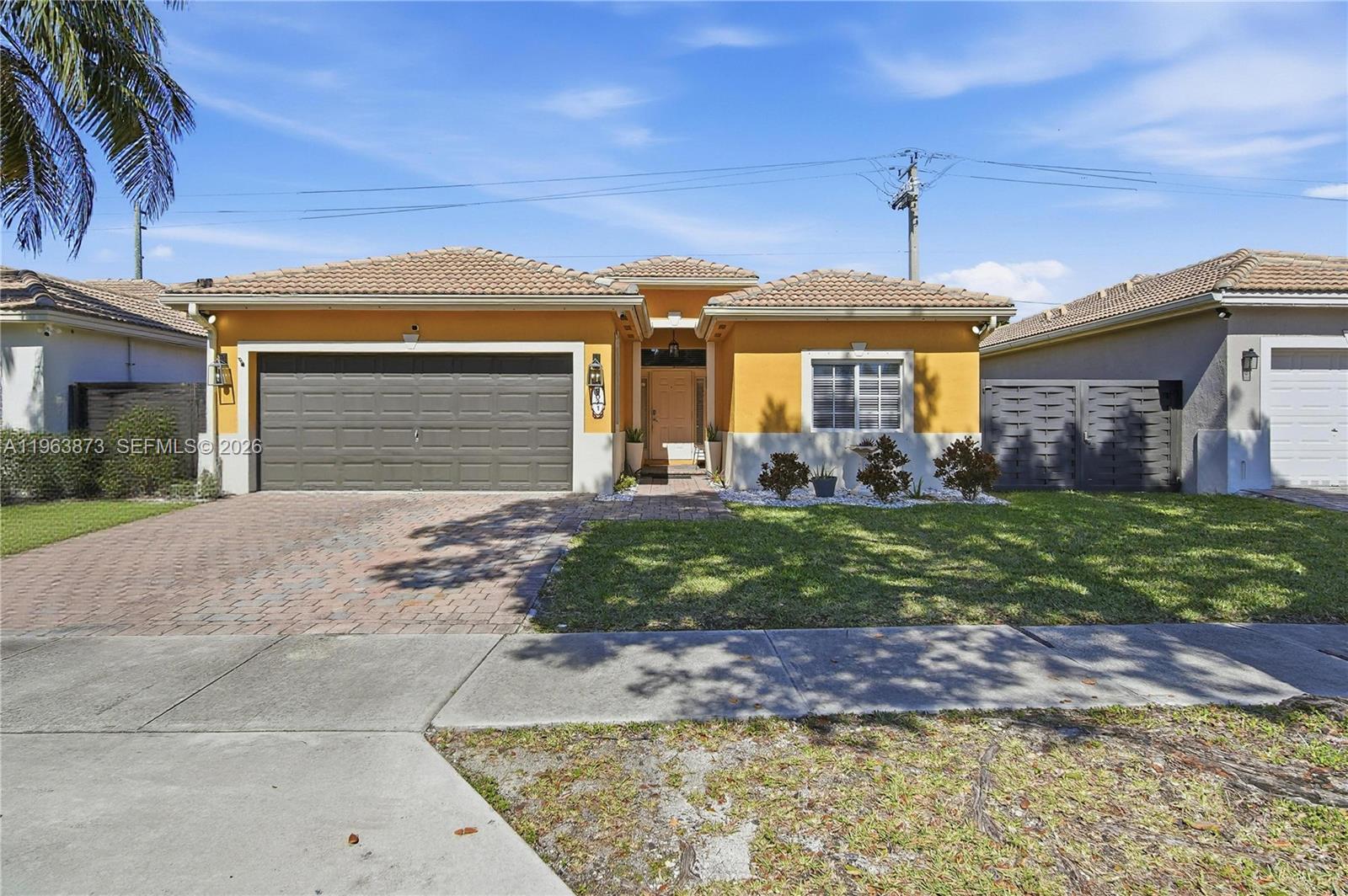 Beautifully maintained 3-bedroom, 2-bathroom single-family residence featuring a spacious split-bedroom floor plan designed for comfort and privacy. Tile flooring flows throughout the main living areas, complemented by a dedicated laundry room and a two-car garage.The expansive primary suite offers two closets, including one with custom built-ins. The primary bathroom features a glass-enclosed shower and a relaxing Jacuzzi tub.The kitchen offers a functional and inviting layout, complete with stainless steel appliances, a dual sink, pantry, and a generous eat-in bar that opens seamlessly to the family room. Custom built-ins in the family room provide the perfect space for a home office, media center, or additional storage.Step outside to your private outdoor oasis with a covered patio overlooking a sparkling modern pool and Jacuzzi — ideal for entertaining or enjoying South Florida living year-round.Located in a highly desirable area with low HOA fees, just minutes from Black Point Marina, the Turnpike, shopping centers, dining, and more.