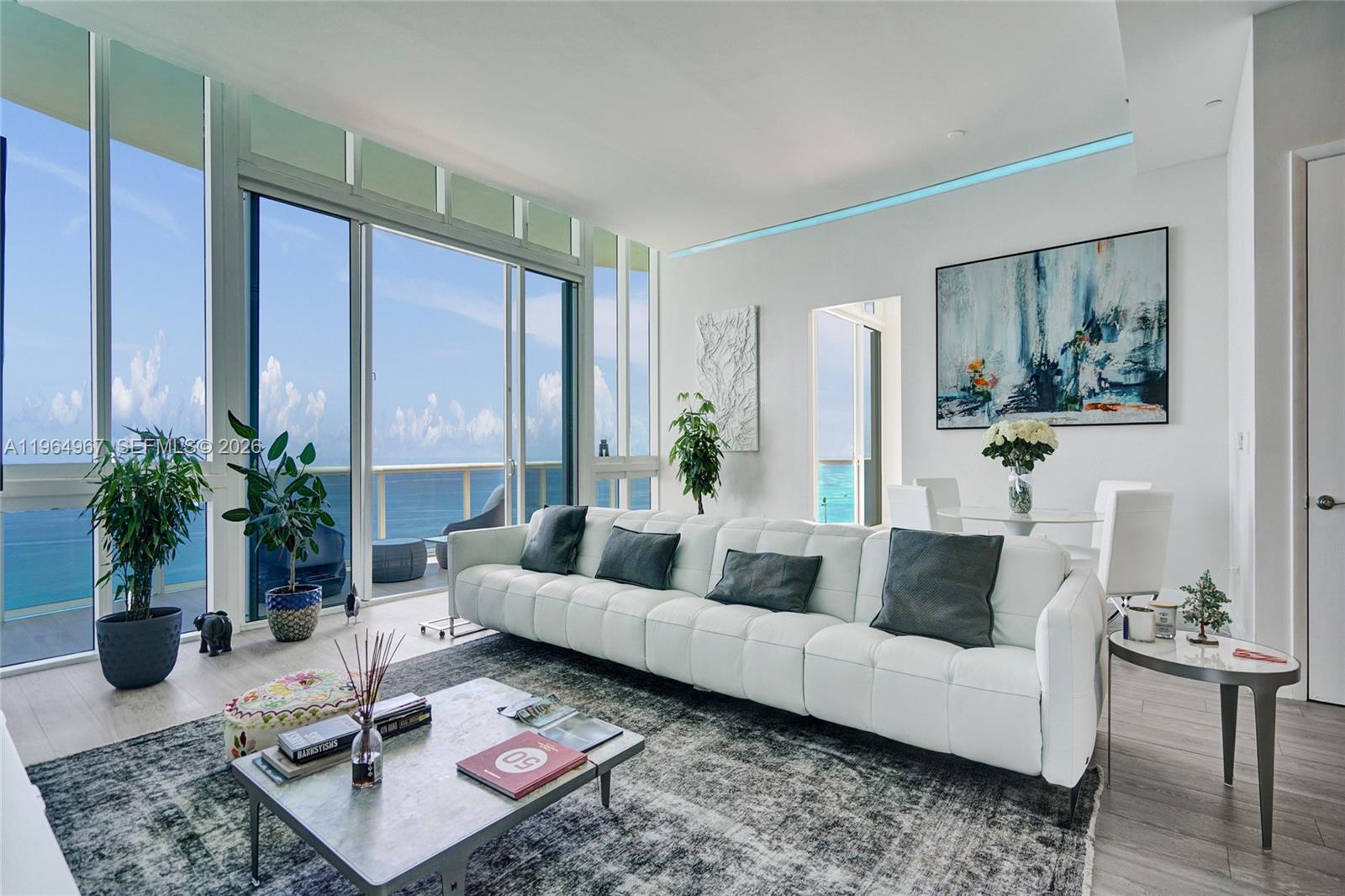 Penthouse living at its finest. This exquisitely appointed 3BR/3.5BA corner residence rises from the 43rd floor of Trump Tower II—the first-ever non-developer resale in the coveted 01 line—delivering unobstructed ocean, city, and Intracoastal views from sunrise through sunset. Newly painted and thoughtfully styled with curated, modern design touches, the home has benefited from significant investment in upgrades—approximately $100,000+, including motorized shades and blackout treatments throughout, professional painting, a custom laundry room build-out for enhanced functionality and storage, and clean, minimalist A/C vent upgrades that complement the refined aesthetic. These are just a few of the enhancements completed, along with additional improvements that further elevate the home's comfort, presentation, and ease of living. The gourmet kitchen and expansive primary suite anchor daily living, while a wraparound balcony with direct ocean exposure creates a true indoor-outdoor penthouse experience with panoramic views spanning three exposures. At this height, you live above it all—unmatched privacy, light, and scale that lower floors simply cannot offer. Move-in ready, with over $100K already invested—nothing left to do but enjoy the lifestyle. Enjoy Trump Tower II's 5-star lifestyle with on-site restaurant, beach service, spa, fitness center, pool, concierge, and valet—all in a prime Sunny Isles Beach location just minutes to Bal Harbour Shops and Aventura Mall.