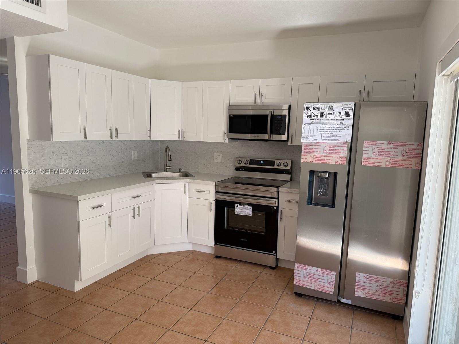 Beautifully Remodeled Townhouse with New Kitchen Cabinets, Quartz Countertops, New Stainless Steel Appliances, All new Light Fixtures, Baseboards, Electrical Outlets, Closet Doors and completely painted.Large patio, Large Closet space, 2 assigned parking spaces. Located within minutes to Dolphin Mall, FIU and Miami Airport. This is a great location in a totally remodeled condition. Ready to move in now!