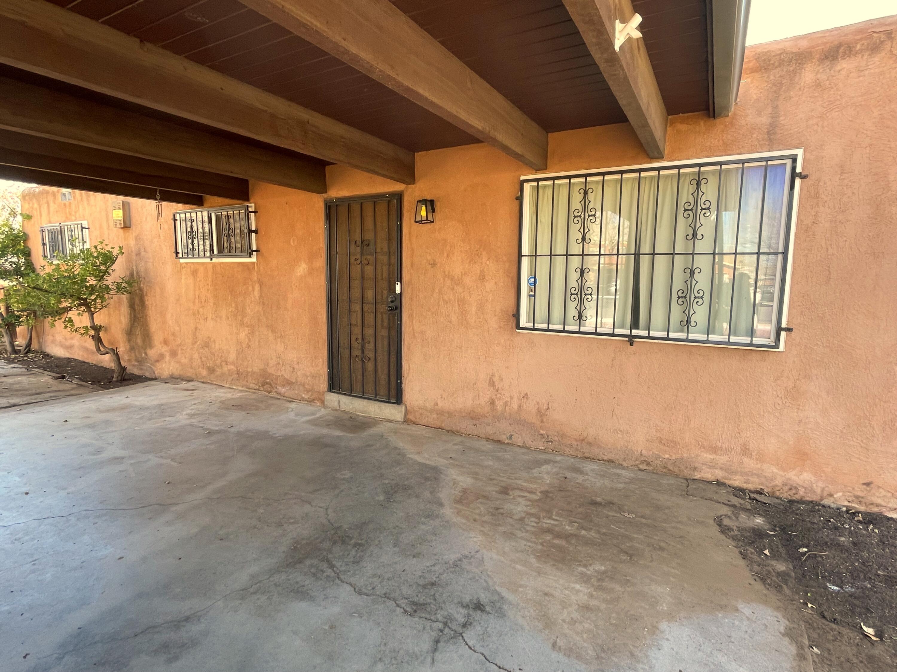 Nice home sitting on Cul-de-Sac' South, with access to carport in front of the house and ample front yard for enjoy/entertaining. Dining area has a Kiva fireplace. Ample kitchen includes breakfast area. Home Needs some of TLC for  you to give it your own touch.  Only 3 miles to Downtown, I-25 , University Stadium, Isotopes Park, The Pit and 5 miles to Albuquerque International Sun port.
