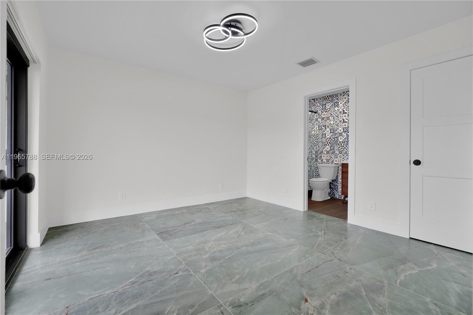 Well-appointed guest bedroom at 5980 40th Ave - Luxury Estate in Dania Beach