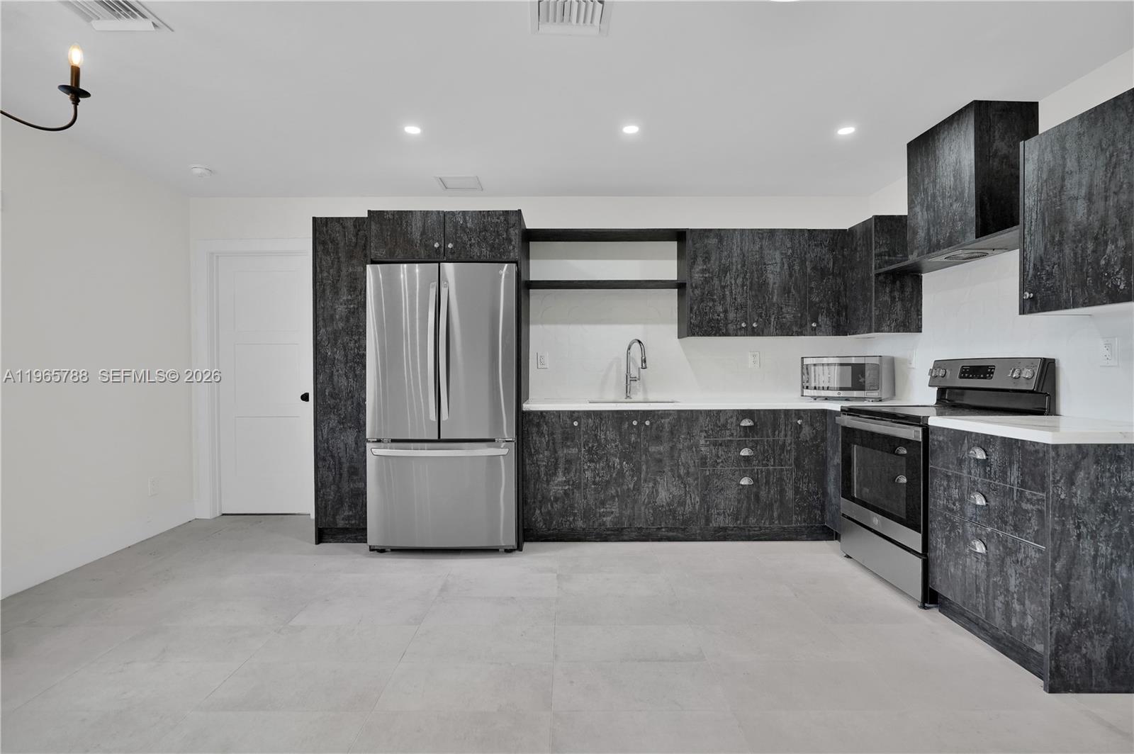 Modern kitchen with designer features at 5980 40th Ave - Luxury Estate in Dania Beach