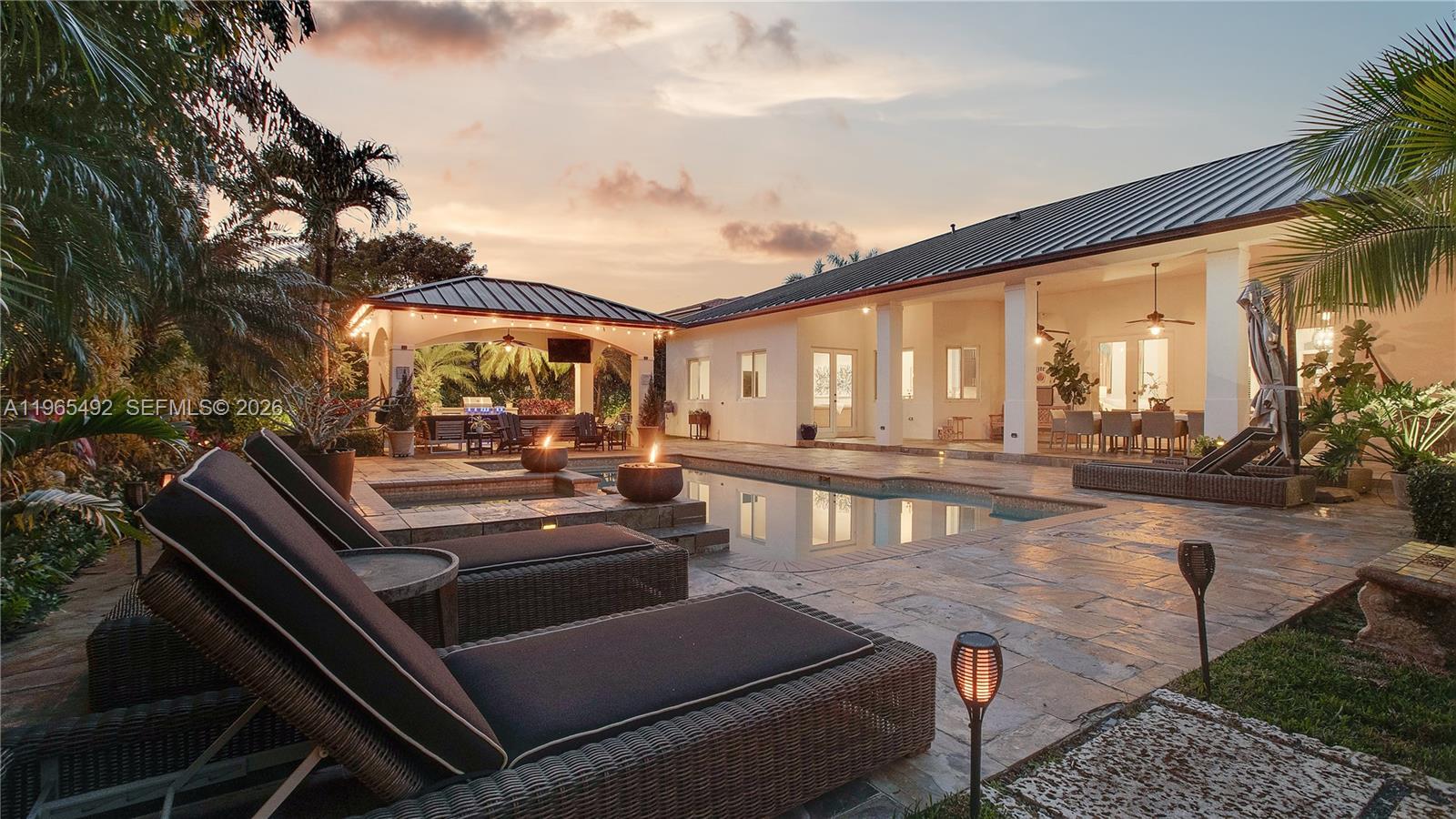Now Repositioned at $2,599,000...Best Value Opportunity in Palmetto BayOwner-built and thoughtfully upgraded, this expansive 6-bedroom, 5-bath residence offers soaring 14 to 16 ft ceilings and over 5,300 SF of living space designed for comfort and entertaining.Major capital improvements provide long-term peace of mind: 2020 double-insulated dark bronze metal roof, impact windows throughout, matching bronze gutters, interior and exterior repaint (2020), two new A/C systems (2023), new pool pump (2024), and new sprinkler pump (2026).The outdoor setting is a true highlight with a gorgeous pool area surrounded by mature trees, coral rock fire pit, and a 2023 Paradise Grill outdoor kitchen with built-in refrigerator, ideal for gatherings year-round.Located on a quiet, secluded street with a two-car garage plus additional front carport, this home offers privacy while remaining close to premier schools including Palmer Trinity and Westminster Christian.Now strategically priced to reflect today’s market, this property presents a rare opportunity to secure space, quality construction, and lifestyle in one of Palmetto Bay’s most desirable locations. This is not a house that needs a renovation project. It is a complete, move-in-ready estate for the buyer who refuses to compromise on space, privacy, or lifestyle at a value that Coral Gables and Pinecrest simply cannot match.Schedule your private tour today.