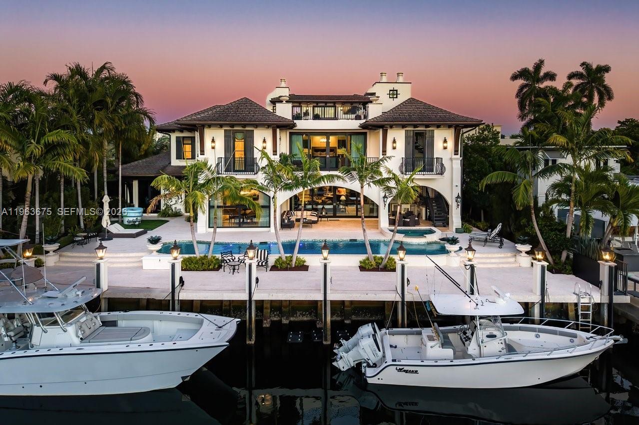 A masterfully crafted Mediterranean estate of scale, presence, and charm, this custom three-story residence commands 100 feet of prime waterfront in the heart of Las Olas Isles. Designed for grand living and entertaining alike, the home is enriched by meticulous detail, generous living areas, and timeless architectural design throughout. A dramatic two-story foyer opens to expansive formal living and dining rooms with a custom wine cellar and built-in saltwater aquarium, while the gourmet chef’s kitchen centers around a one-of-a-kind statement island.The main level reveals a breakfast room, butler’s pantry, executive office with cylindrical aquarium and custom millwork, wet bar, VIP guest suite, cabana bath, and integrated service spaces. The waterfront primary suite offers serene water views, his-and-hers spa-caliber baths, boutique-style dressing rooms, and a private balcony. Three additional ensuite guest suites, secondary laundry, media lounge, rooftop terrace with full bath and summer kitchen, saltwater pool and spa, two summer kitchens, climate-controlled garages with golf cart bay, and generator complete this exceptional Fort Lauderdale estate.