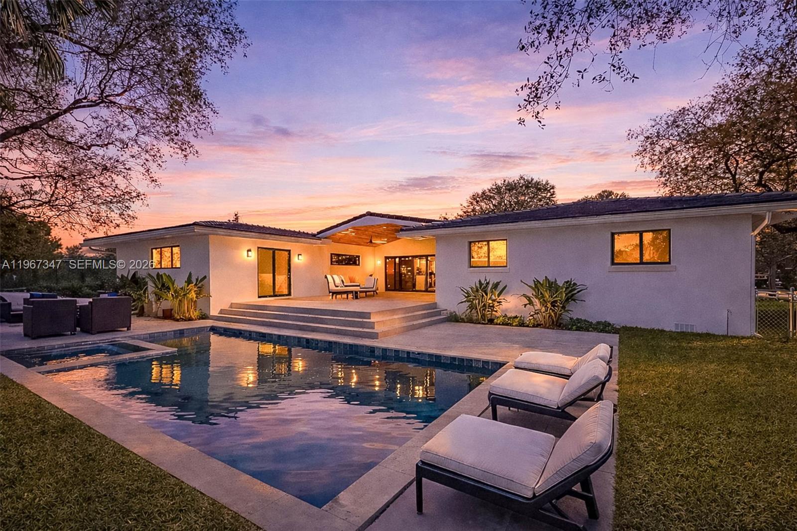 Fully renovated modern 5BD/4BA home in desirable Pinecrest. Open-concept great room with porcelain floors and recessed lighting. Sleek kitchen with island cooktop, counter seating, wall oven, pantry refrigerator and full pantry. Split floor plan with spacious primary suite opening to pool, spa-style bath and oversized walk-in closet. Heated saltwater pool, covered patio, fenced yard, circular paver driveway plus side entry and 2-car garage. Impact windows/doors, flat tile roof, and new A/C systems. Move-in ready.