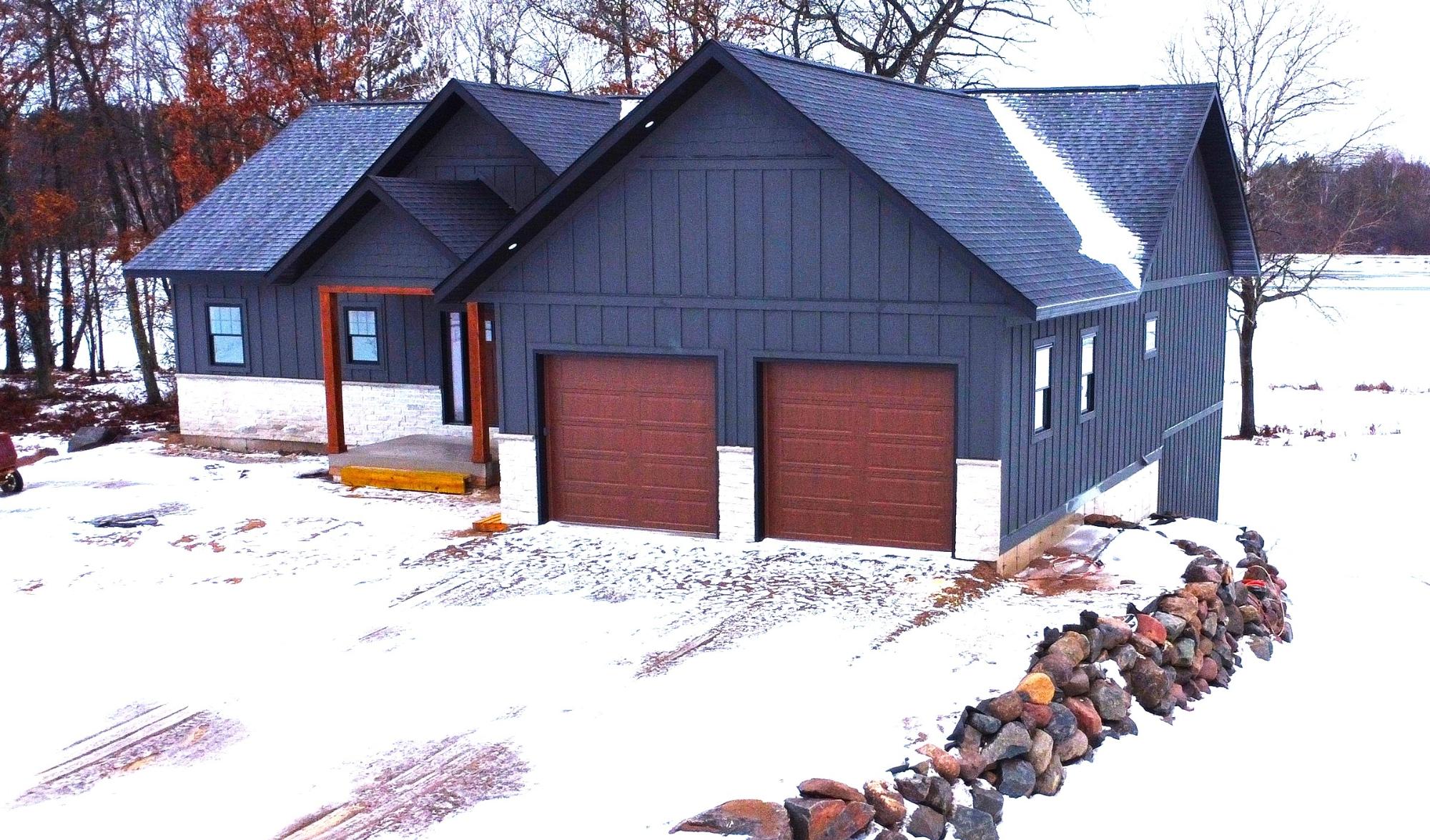 Brand new construction on Lake Mohawksin, part of the scenic Wisconsin River chain! This stunning 3,000+ finished sq ft home offers 4 bedrooms and 3 baths with an open-concept design and soaring cathedral ceilings. Expansive windows showcase breathtaking water views from every room. The main level features a spacious living area, designer kitchen, and convenient laundry, with a second laundry on the lower level for added ease. The full walk-out basement provides generous living and entertaining space. Enjoy 500 sq ft of low-maintenance composite decking overlooking the water—perfect for relaxing or hosting. LP siding, city sewer and water, and quality craftsmanship throughout complete this exceptional waterfront opportunity. On ATV/UTV trail. Schedule a showing today! All Data approximate, Buyer to verify all information.