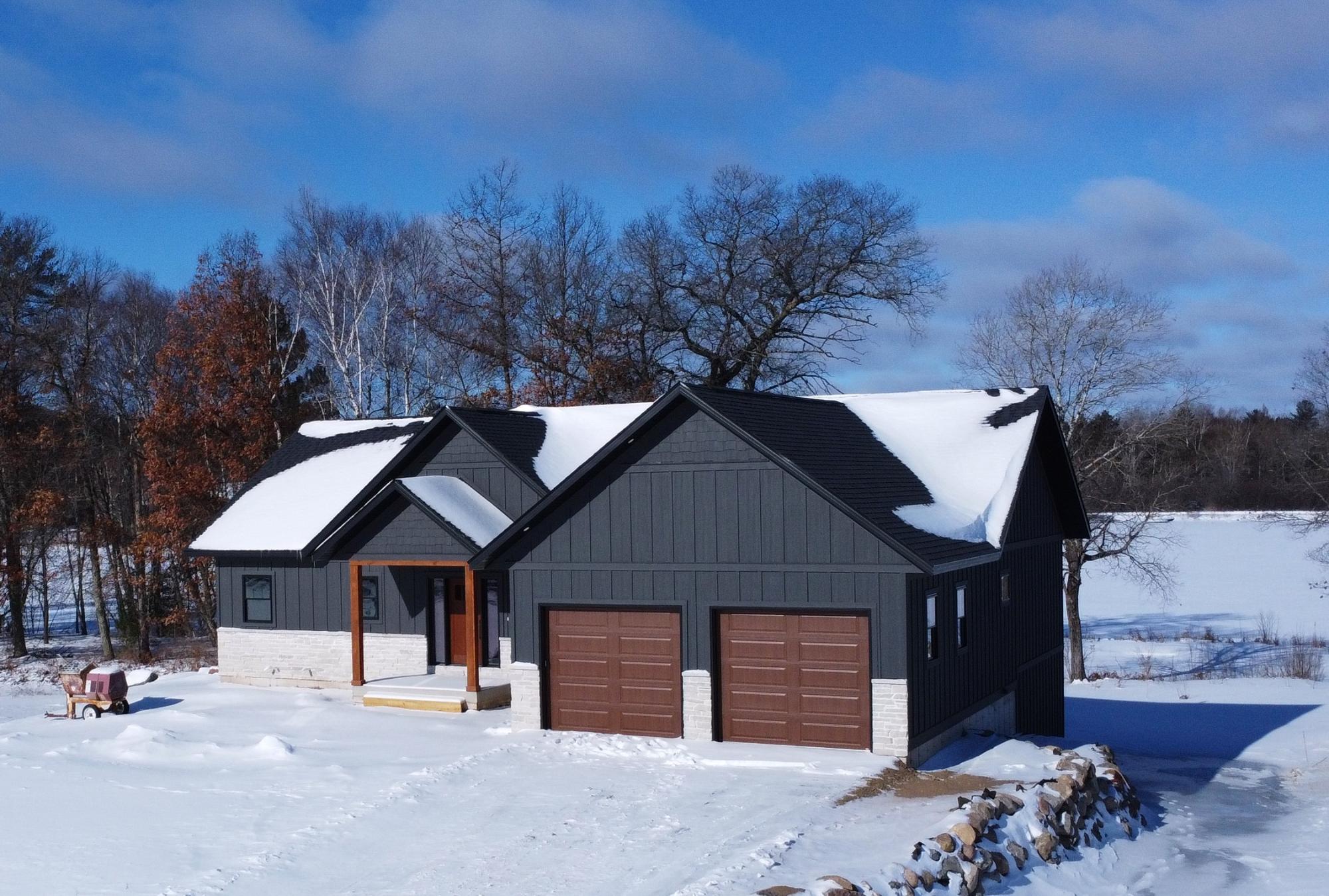 Brand new construction on Lake Mohawksin, part of the scenic Wisconsin River chain! This stunning 3,000+ finished sq ft home offers 4 bedrooms and 3 baths with an open-concept design and soaring cathedral ceilings. Expansive windows showcase breathtaking water views from every room. The main level features a spacious living area, designer kitchen, and convenient laundry, with a second laundry on the lower level for added ease. The full walk-out basement provides generous living and entertaining space. Enjoy 500 sq ft of low-maintenance composite decking overlooking the water—perfect for relaxing or hosting. LP siding, city sewer and water, and quality craftsmanship throughout complete this exceptional waterfront opportunity. On ATV/UTV trail. Schedule a showing today! All Data approximate, Buyer to verify all information.