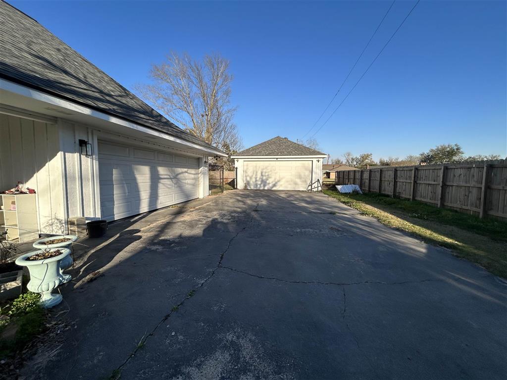 Garage attached by breezeway and detached shop wit