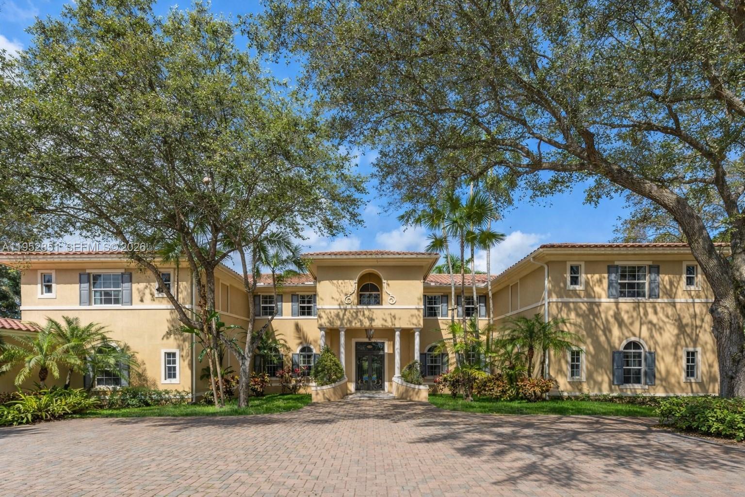 Mediterranean estate in prestigious Pinecrest, gracefully set on a 39,204 sq ft lot. This distinguished 5-bedroom, 5-bath residence with 2 half baths welcomes you with a grand foyer and soaring volume ceilings that create an immediate sense of scale and light. Elegant formal and casual living spaces are thoughtfully designed for refined entertaining. The gourmet kitchen showcases custom cabinetry and a butler’s pantry. A richly appointed club room with bar, private library or office, wine storage, elevator, and summer kitchen overlooking the expansive grounds complete this rare offering of timeless sophistication and elevated living.