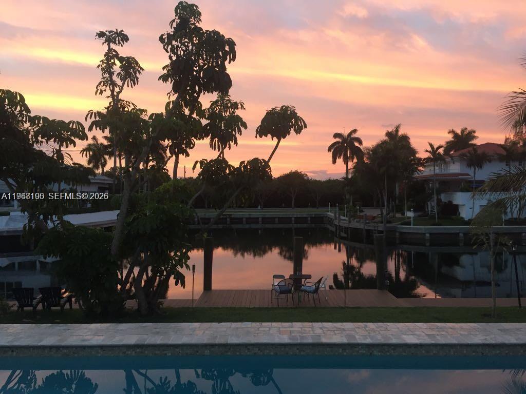 This beautiful house sits on an elevated lot in prestigious Gables by the sea. It features modern finishes, an updated kitchen w/ quartz countertop, 4 spacious bedrooms (2 en-suites), a home theater/den that can double as a 5th bedroom, and 3.5 bathrooms. Enjoy the safety and tranquility provided by impact windows and doors, covered outdoor area, a large 2 car garage and more. The private designer dock and seawall offer the perfect spot to witness breathtaking sunrises and sunsets. As night falls, the underwater lighting turns your dock into a mesmerizing display, showcasing the marine life and creating the ambiance of your own personal aquarium. Located near top-rated A+ schools. Contact owner/agent for showings. *No ocean access*