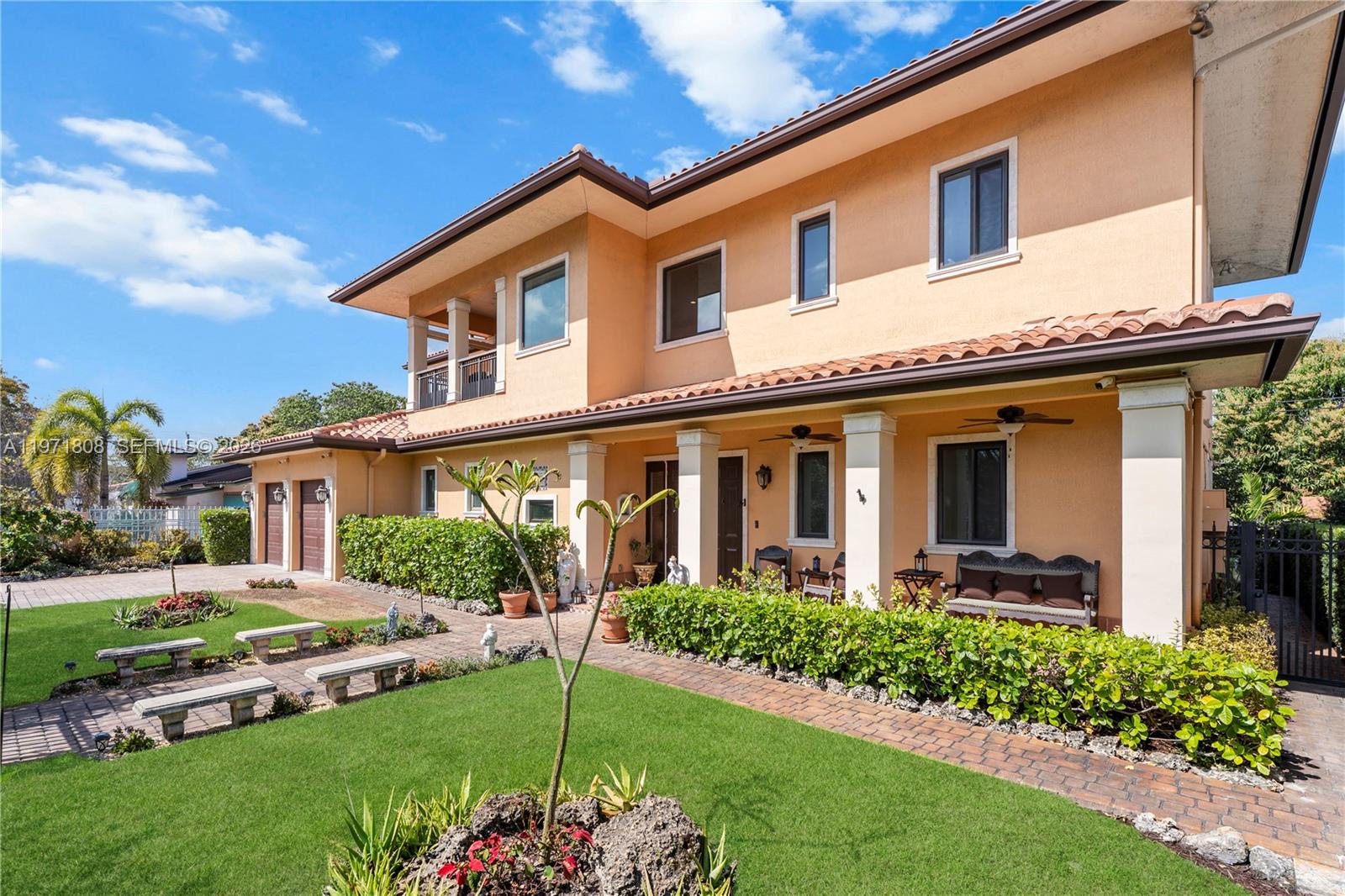 Cuban-inspired custom residence built in 2017, featuring authentic Cuban tile floors and designed with a focus on enduring quality, architectural scale, and craftsmanship. The home offers 3,736 square feet of living area and 3,932 adjusted square feet, including maid’s quarters, laundry room storage, and a dedicated tool room.Constructed of solid concrete block with a concrete roof and classic Spanish “S” tile, the property reflects structural integrity and timeless design. A dramatic entry foyer welcomes with expansive volume ceilings and detailed stone flooring, complemented by custom iron railings and exceptional woodwork throughout.The chef’s kitchen features floor-to-ceiling custom cabinetry, stone countertops, an oversized walk-in pantry, and generous workspace suited for both everyday living and entertaining.Offering four bedrooms, including a primary suite on the ground level with an ensuite bathroom and walk-in closet, plus an additional primary suite upstairs, the layout provides flexibility and comfort. Bathrooms are well-appointed with quality finishes, and custom flooring extends throughout.Impact-rated doors and windows, a gas-powered Generac generator with underground tank, closed-cell foam insulation, and a cistern system enhance the home’s infrastructure.Outdoor spaces include covered terraces, manicured landscaping, a jacuzzi, and a rear patio. Ideally located minutes from Coral Gables, Miracle Mile, Brickell, and Downtown Miami.